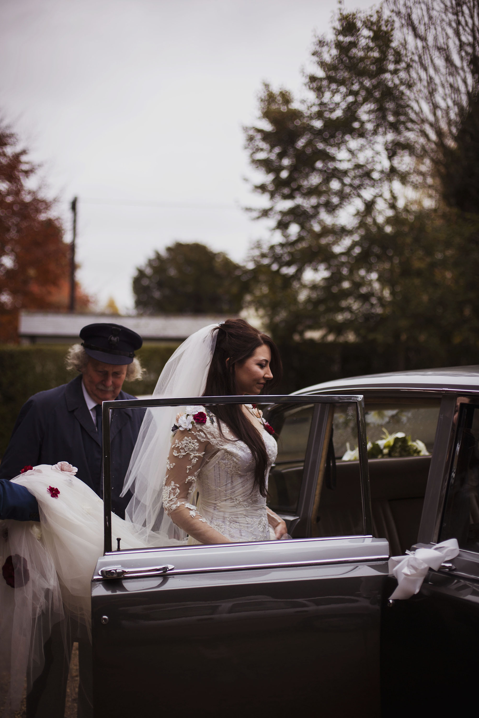 bride getting into car wearing veil at grasmere house hotel