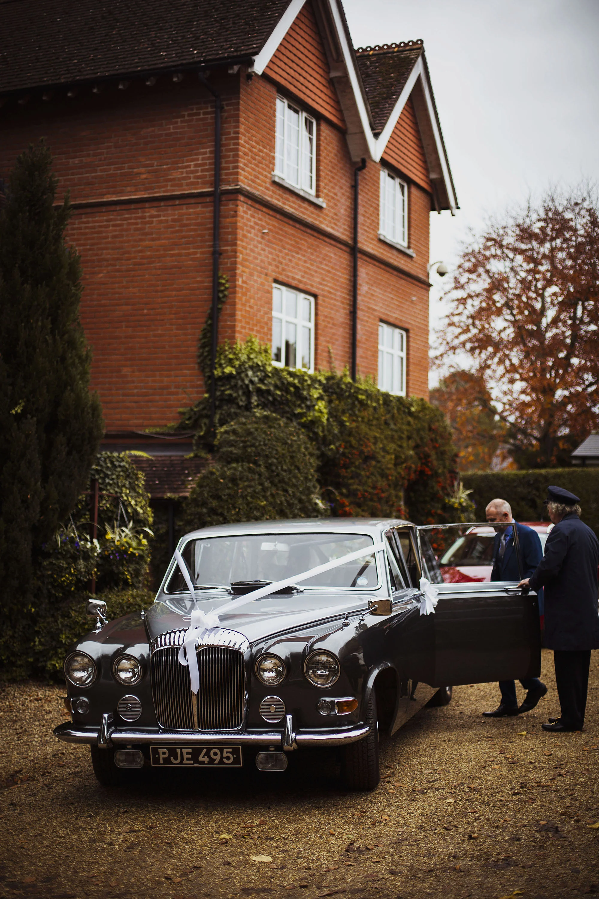 bride getting into vintage car at grasmere house hotel