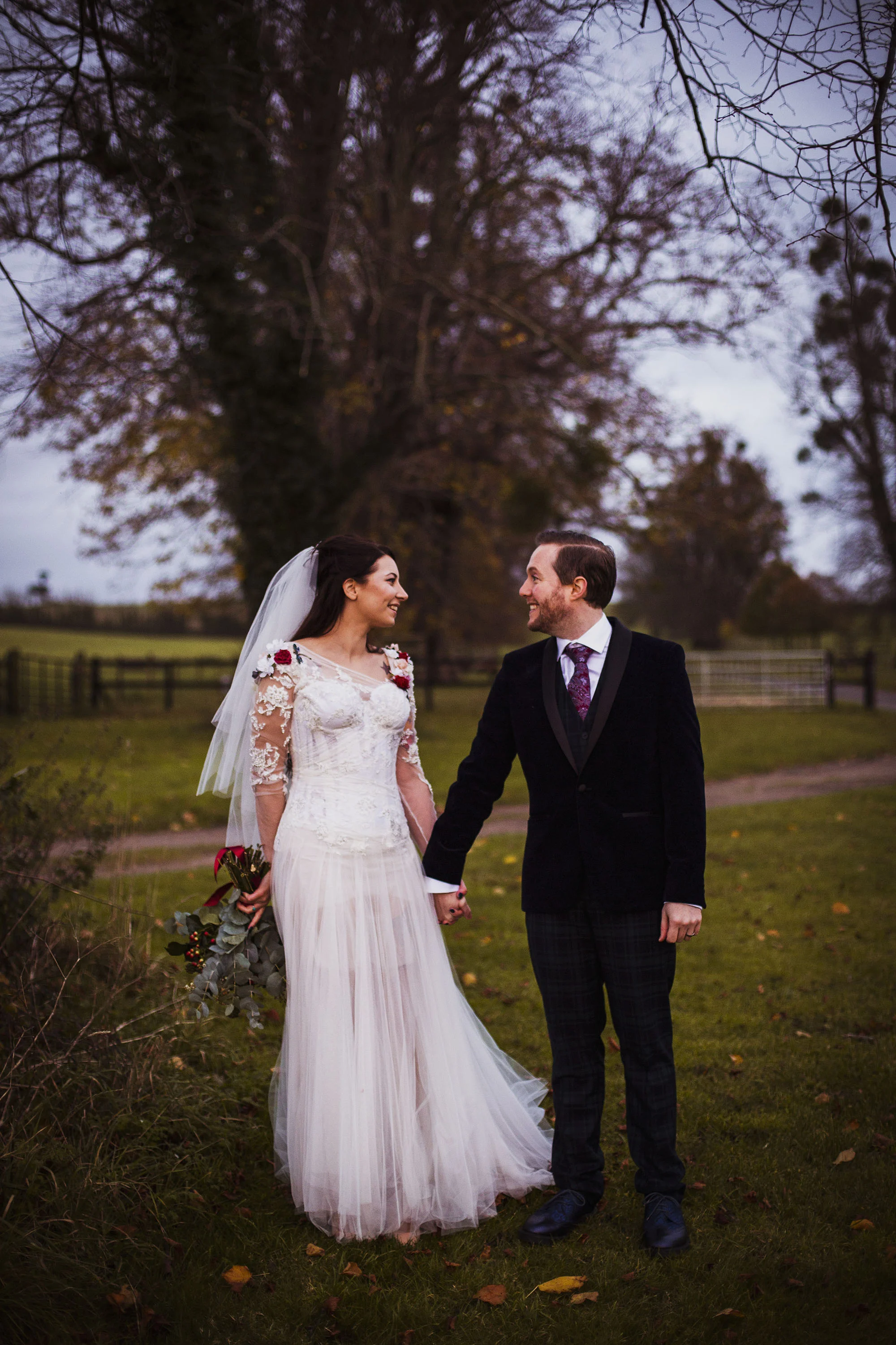 bride and groom smiling at each other at barford park wedding venue in wiltshire
