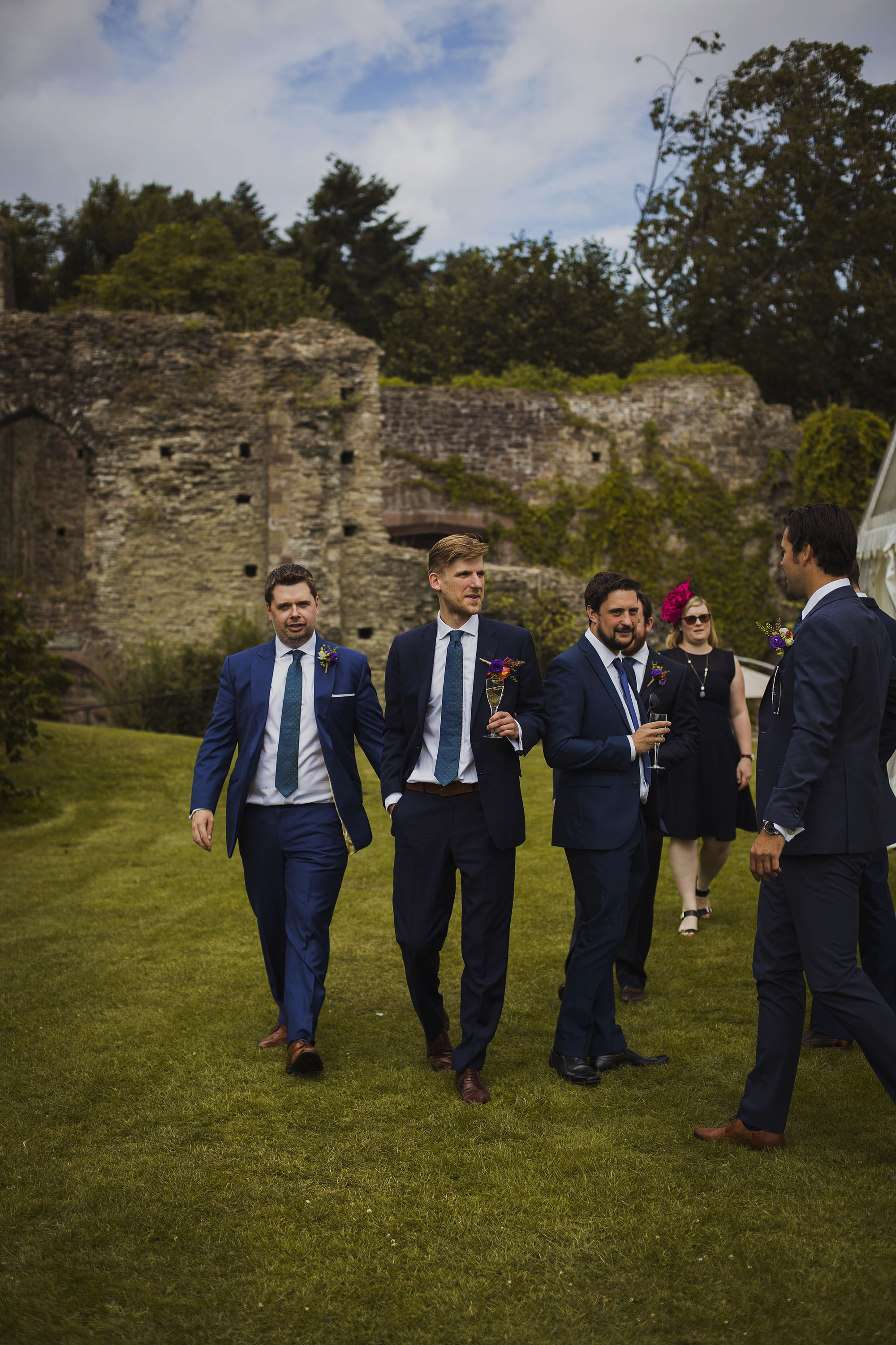 groom holding champagne with groomsmen