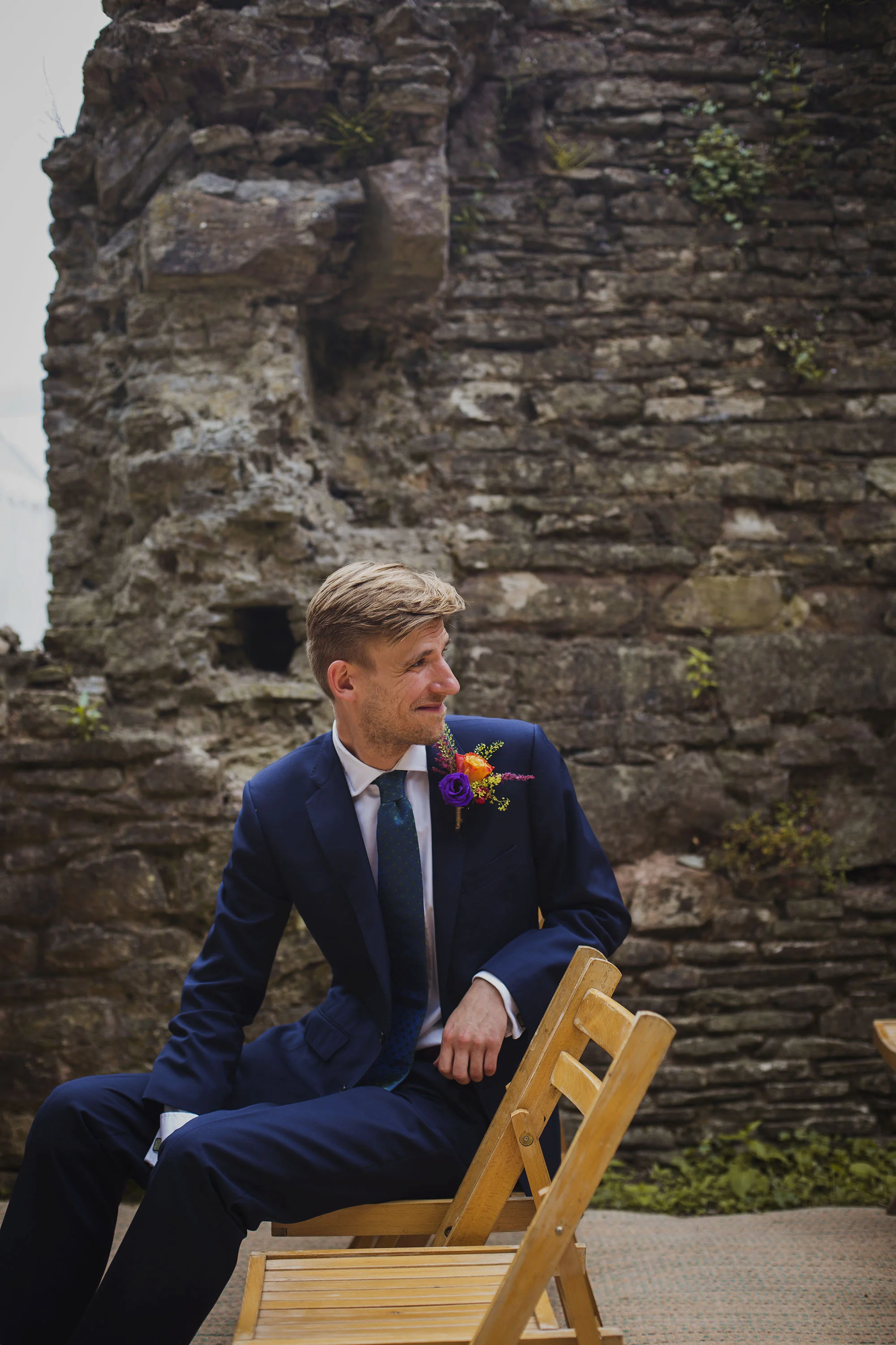 groom smiling as bride arrives at wedding ceremony at usk castle