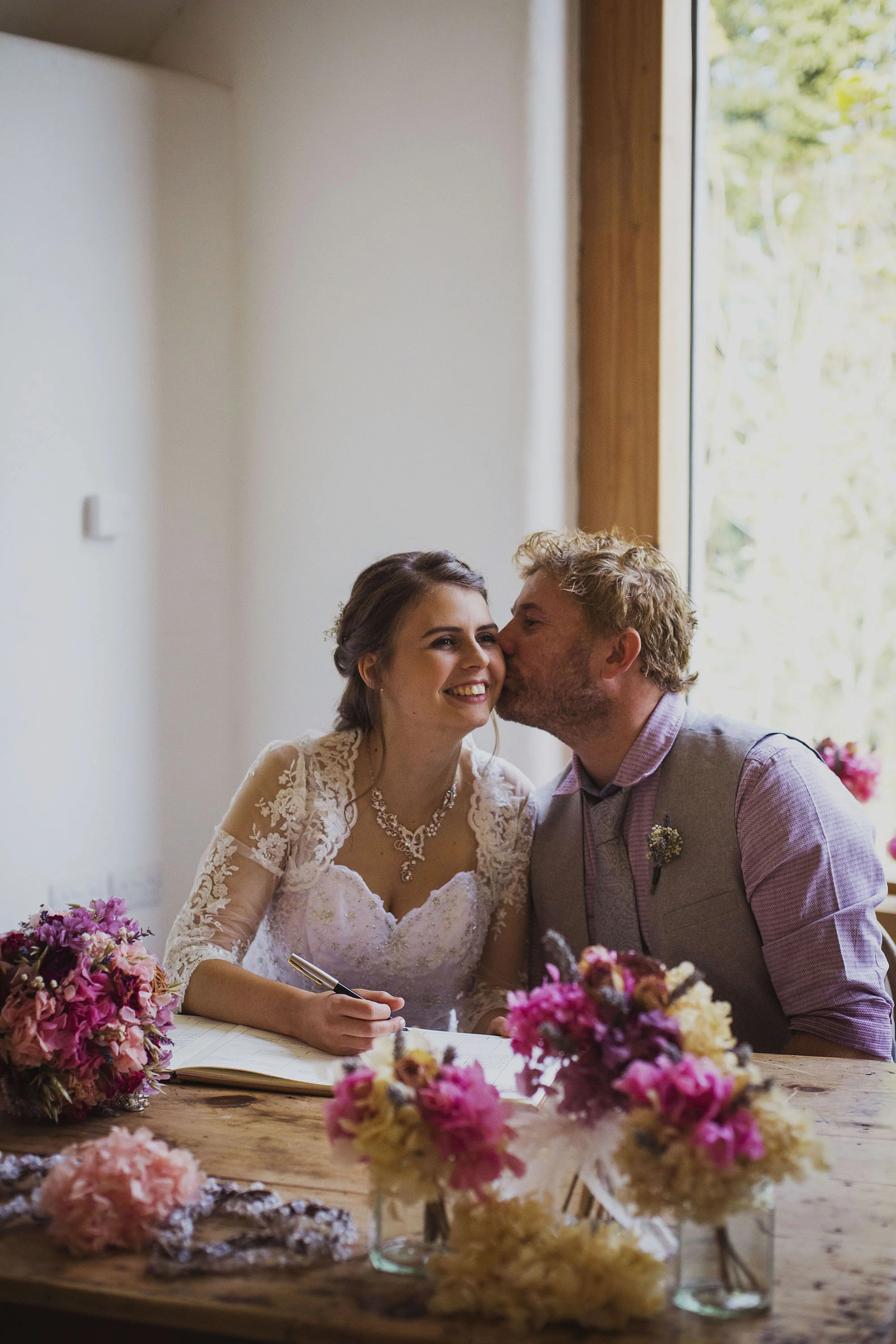 bride and groom signing the register at nantwen wedding venue