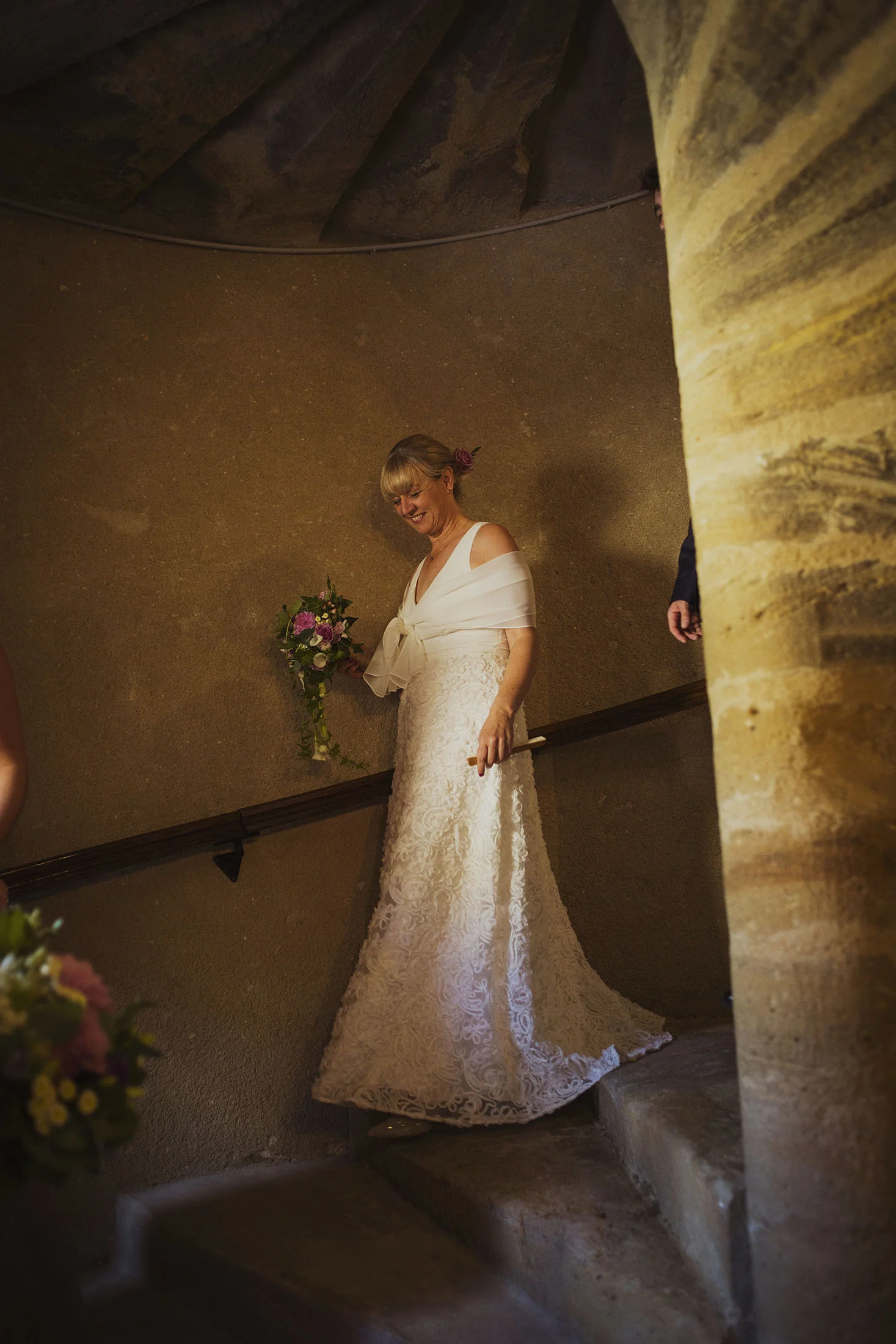 bride walking downstairs at bridal preparations at chateaux des ducs de joyeuses france destination wedding photography