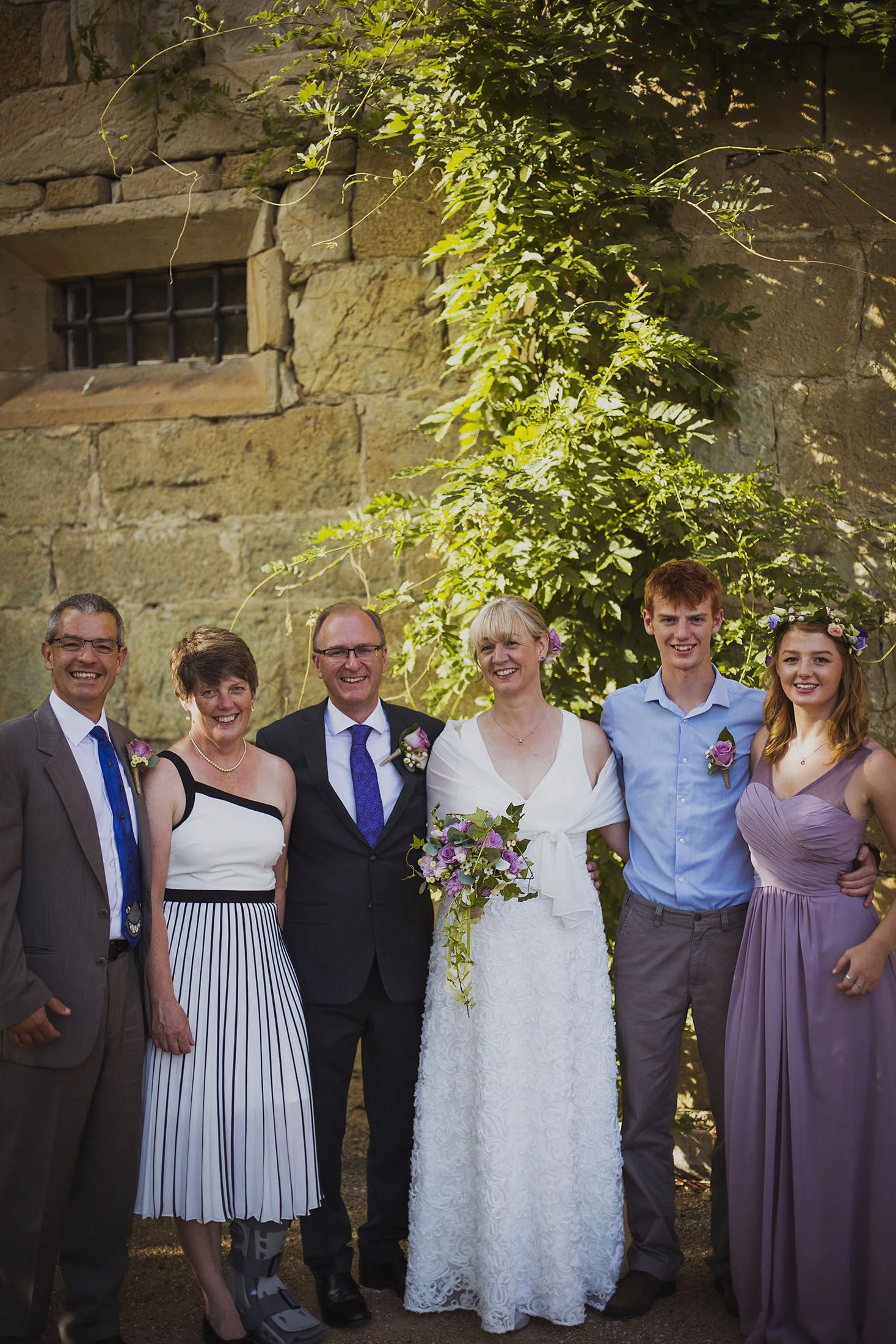 bride and groom with family at chateaux des ducs de joyeuses france destination wedding photography