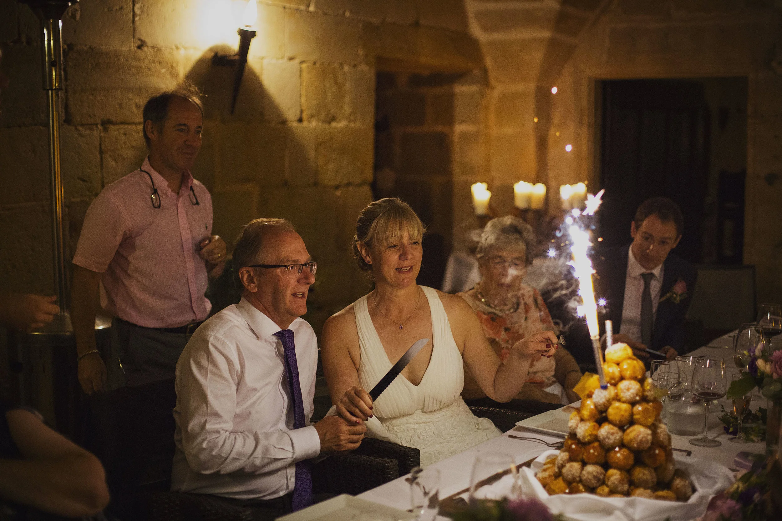 cake cutting at chateaux des ducs de joyeuses france destination wedding photography