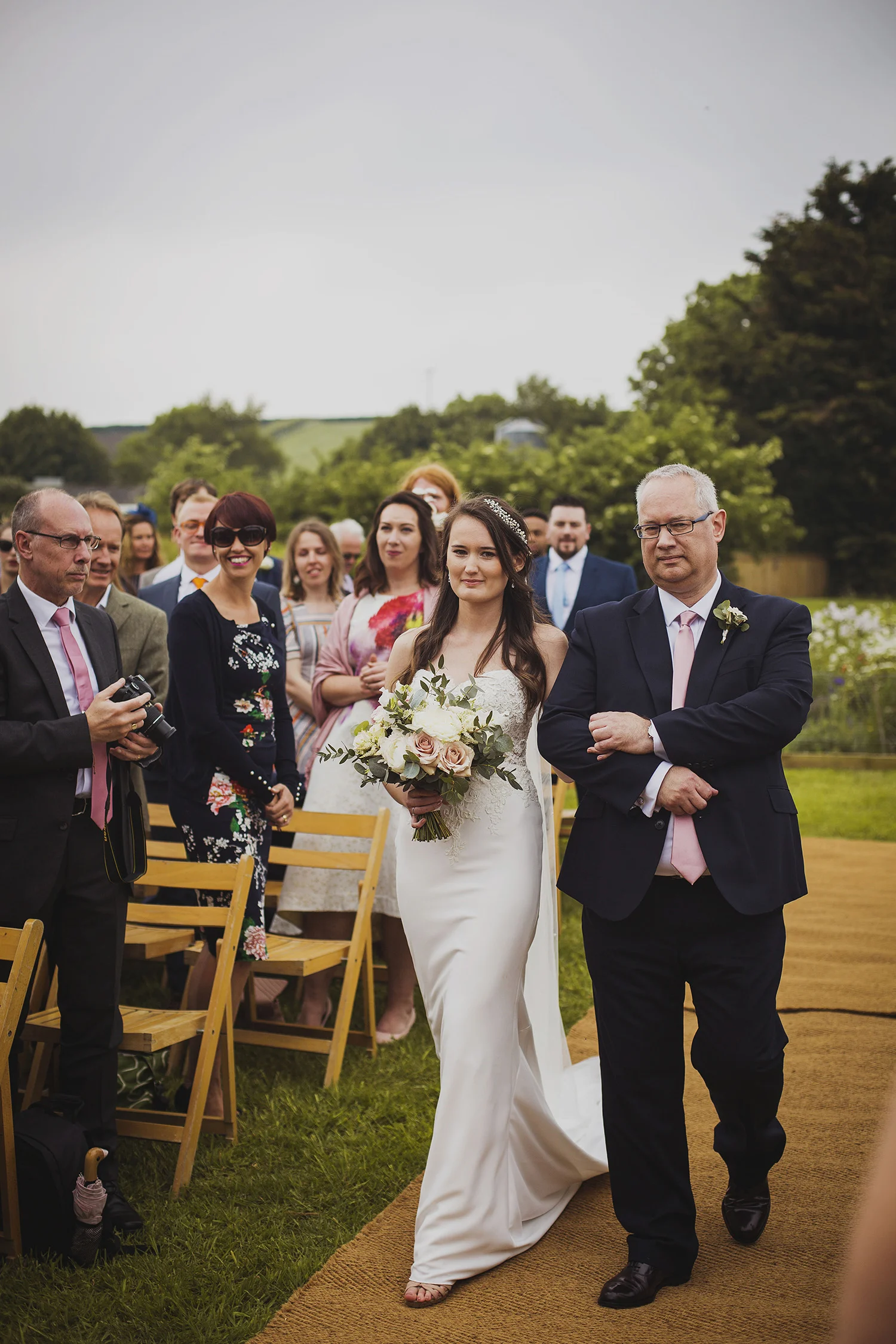 bride walking down the isle at cott farm barn somerset wedding venue