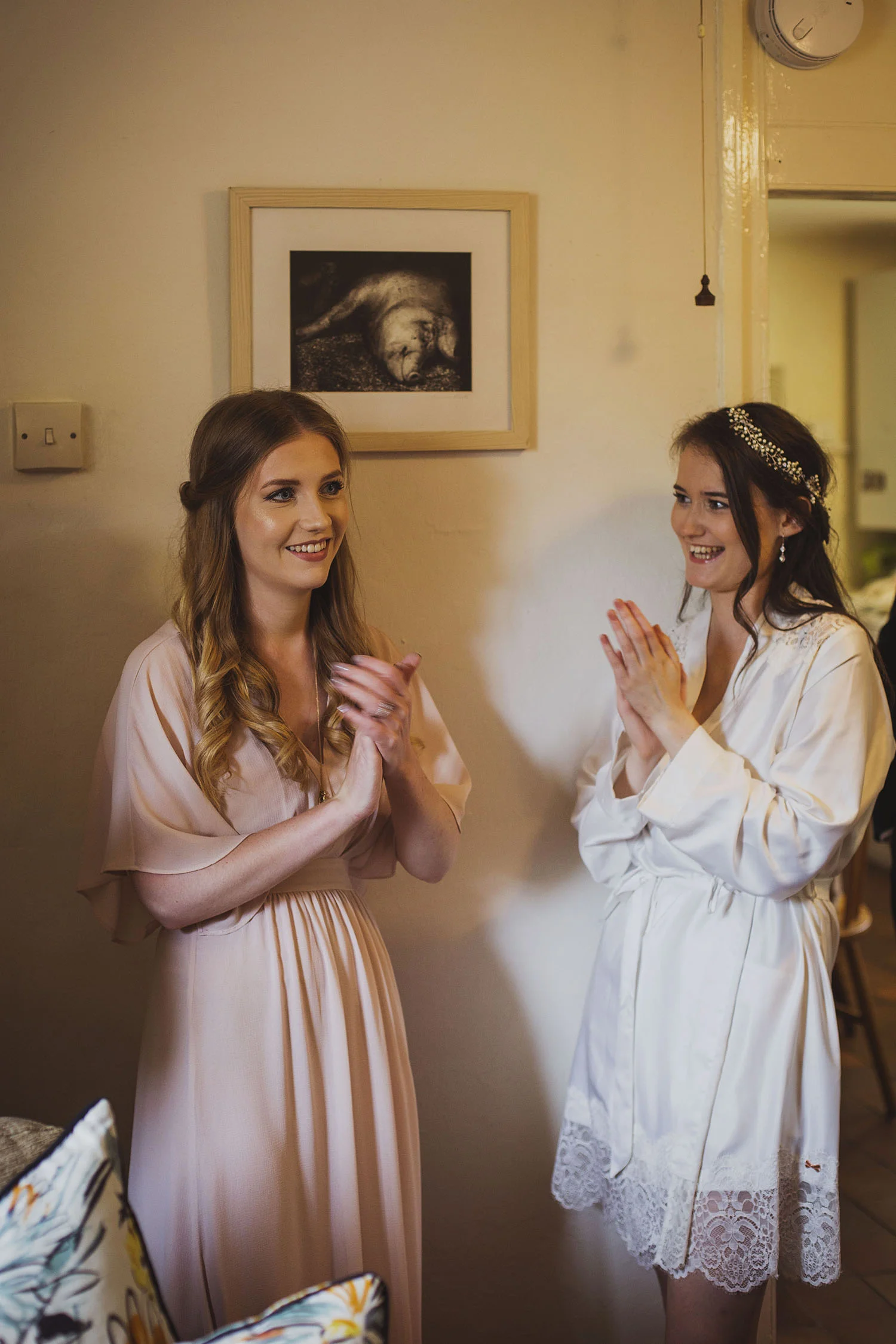 bride and bridesmaid getting ready for cott farm barn somerset wedding