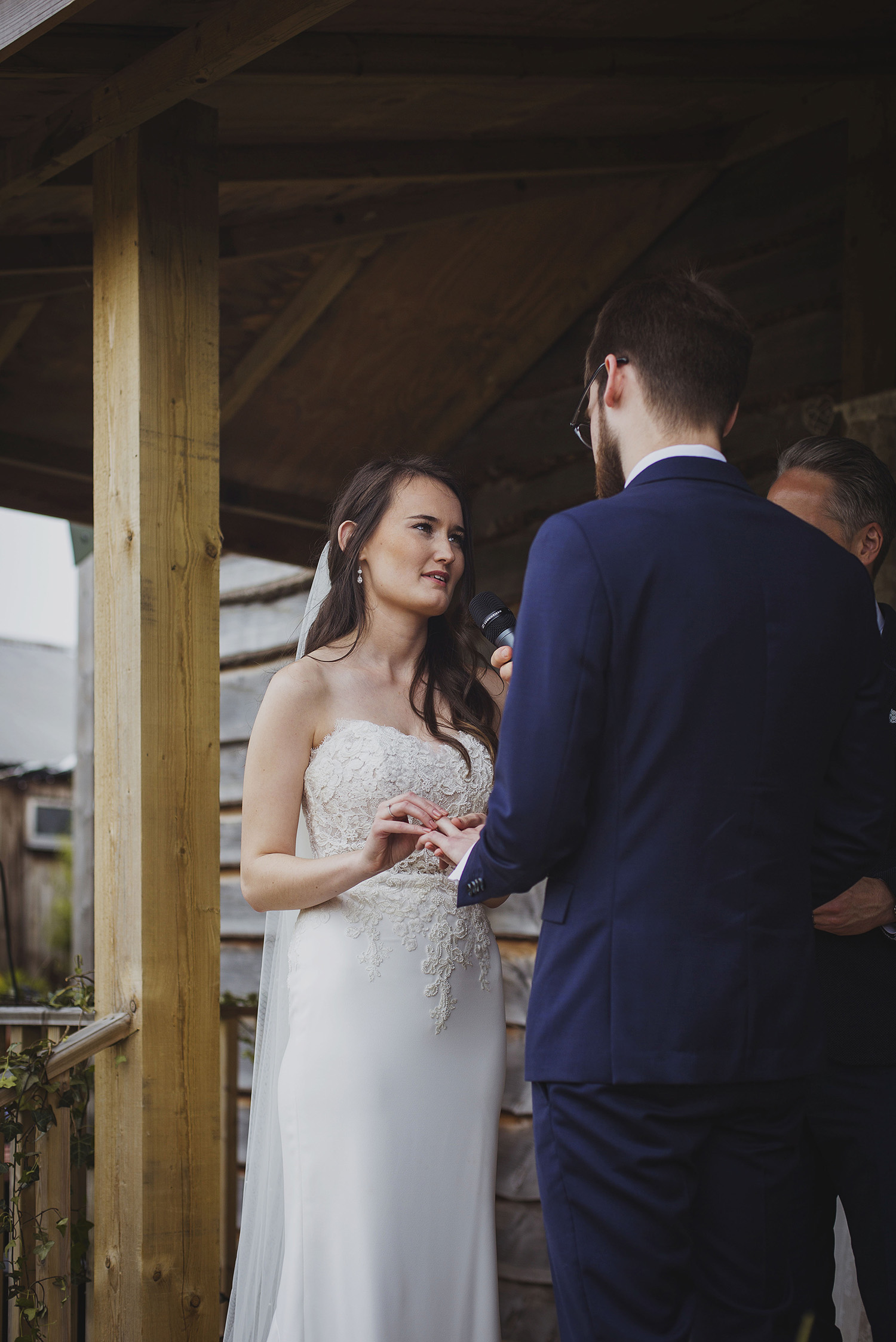 exchanging rings at wedding ceremony at cott farm barn wedding venue somerset