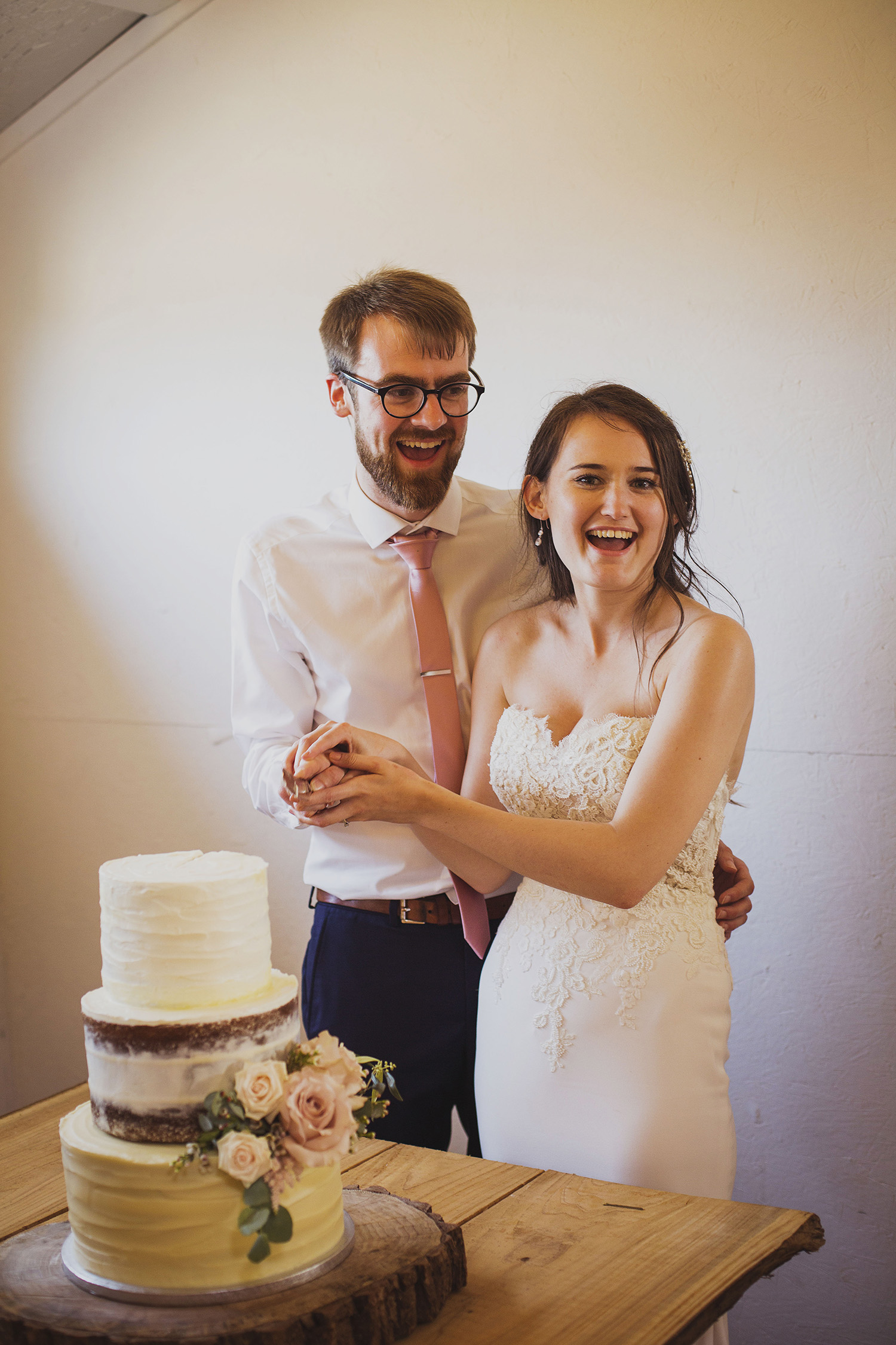 cake cutting at at cott farm barn wedding venue somerset 