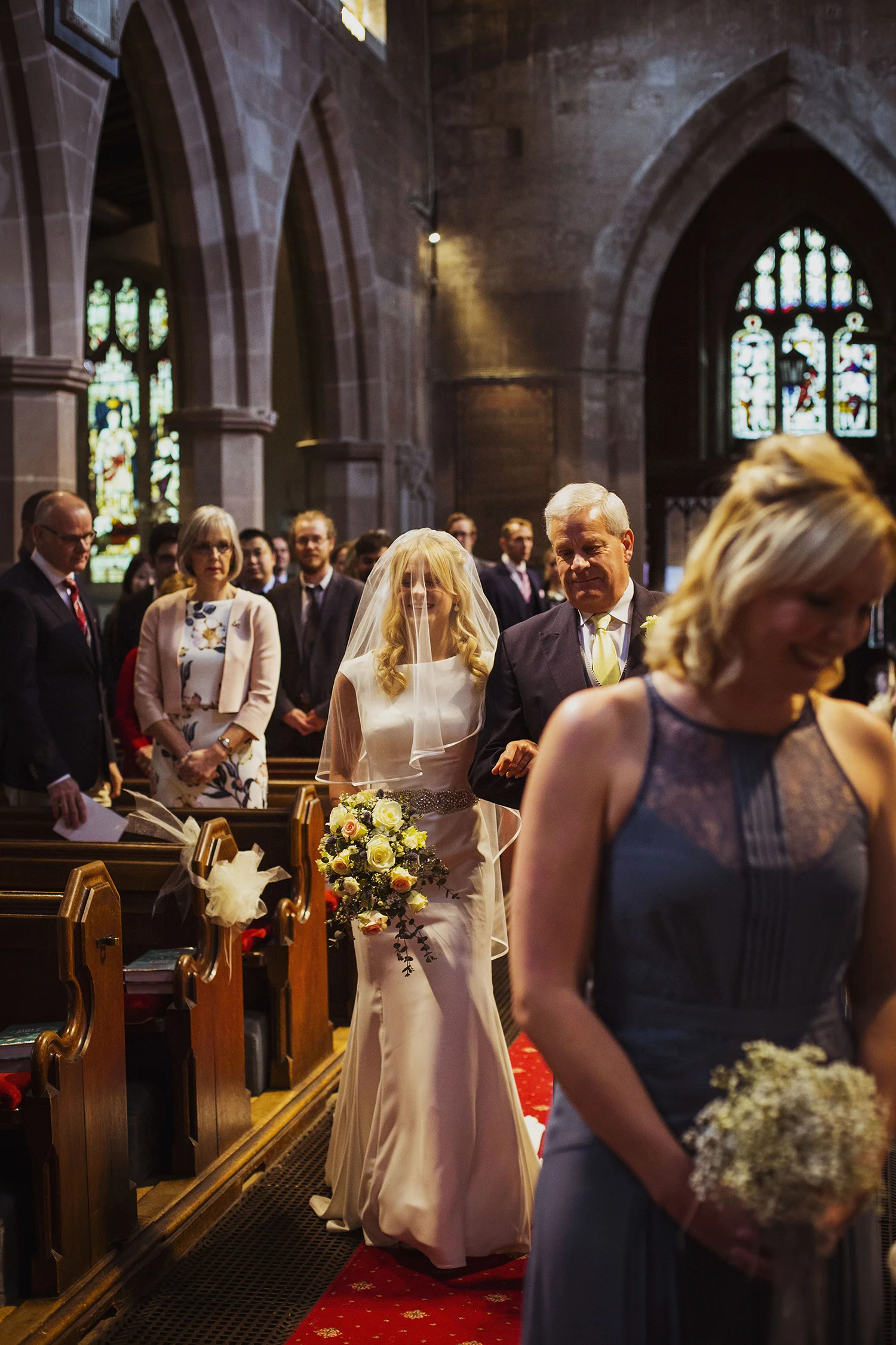 bride walking down the isle at knowle parish church diy wedding