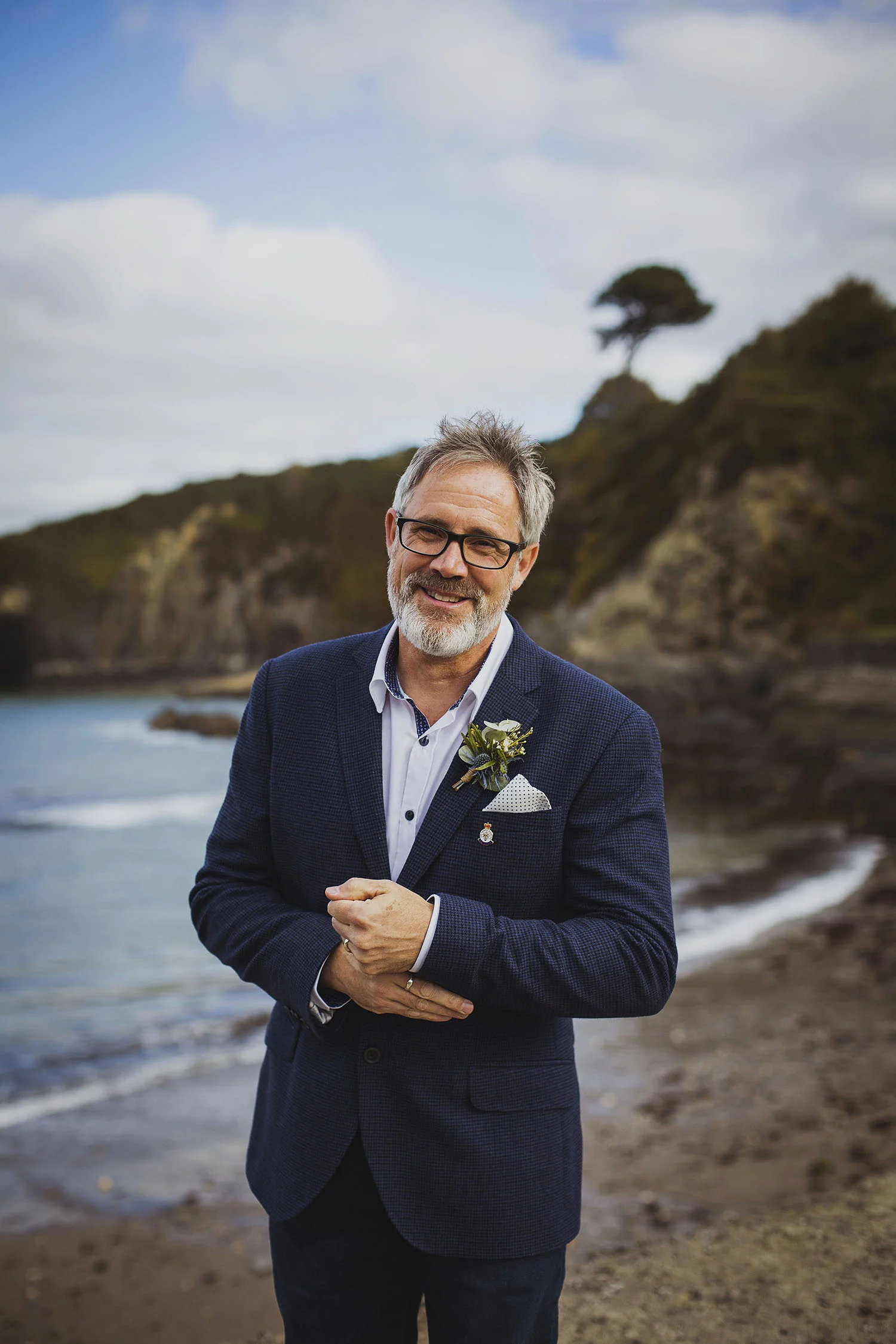 groom with flowers by annabel at beach nantwen wedding pembrokeshire wedding photographer