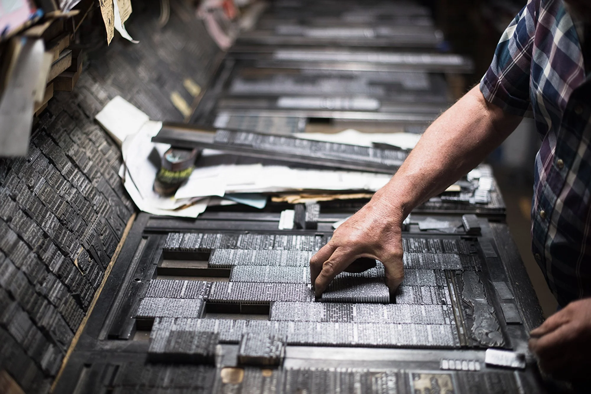 Dean Coombs arranging metal type by hand