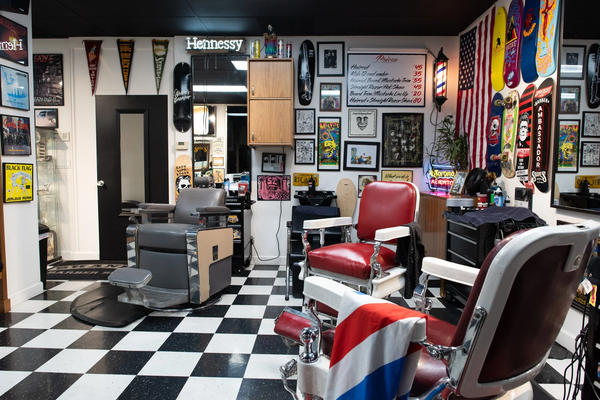 empty interior of Shane's Barbershop San Mateo with barber chairs and artwork on walls