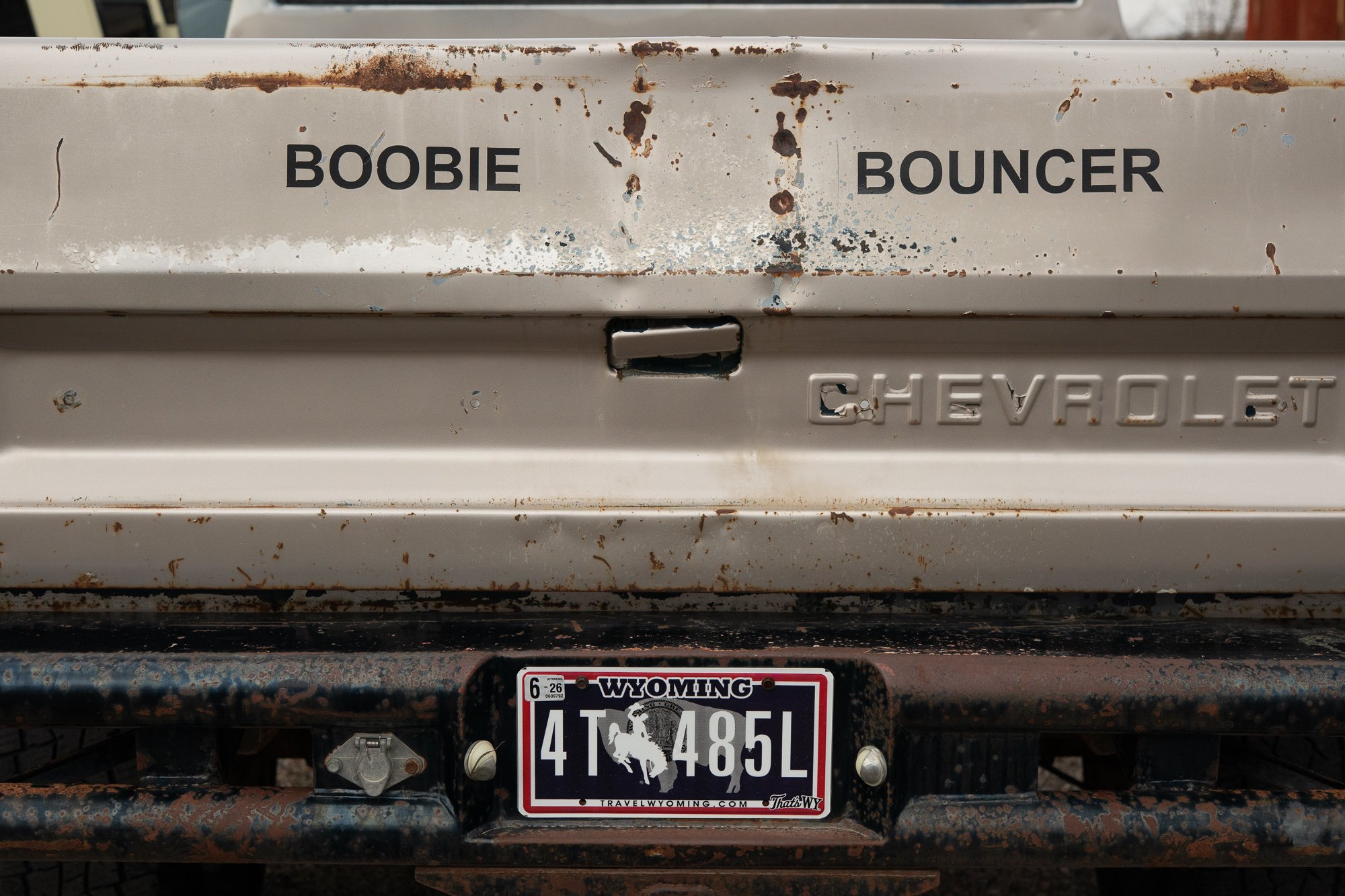 Rusted Chevrolet pickup tailgate with Wyoming license plate in Rock Springs Wyoming