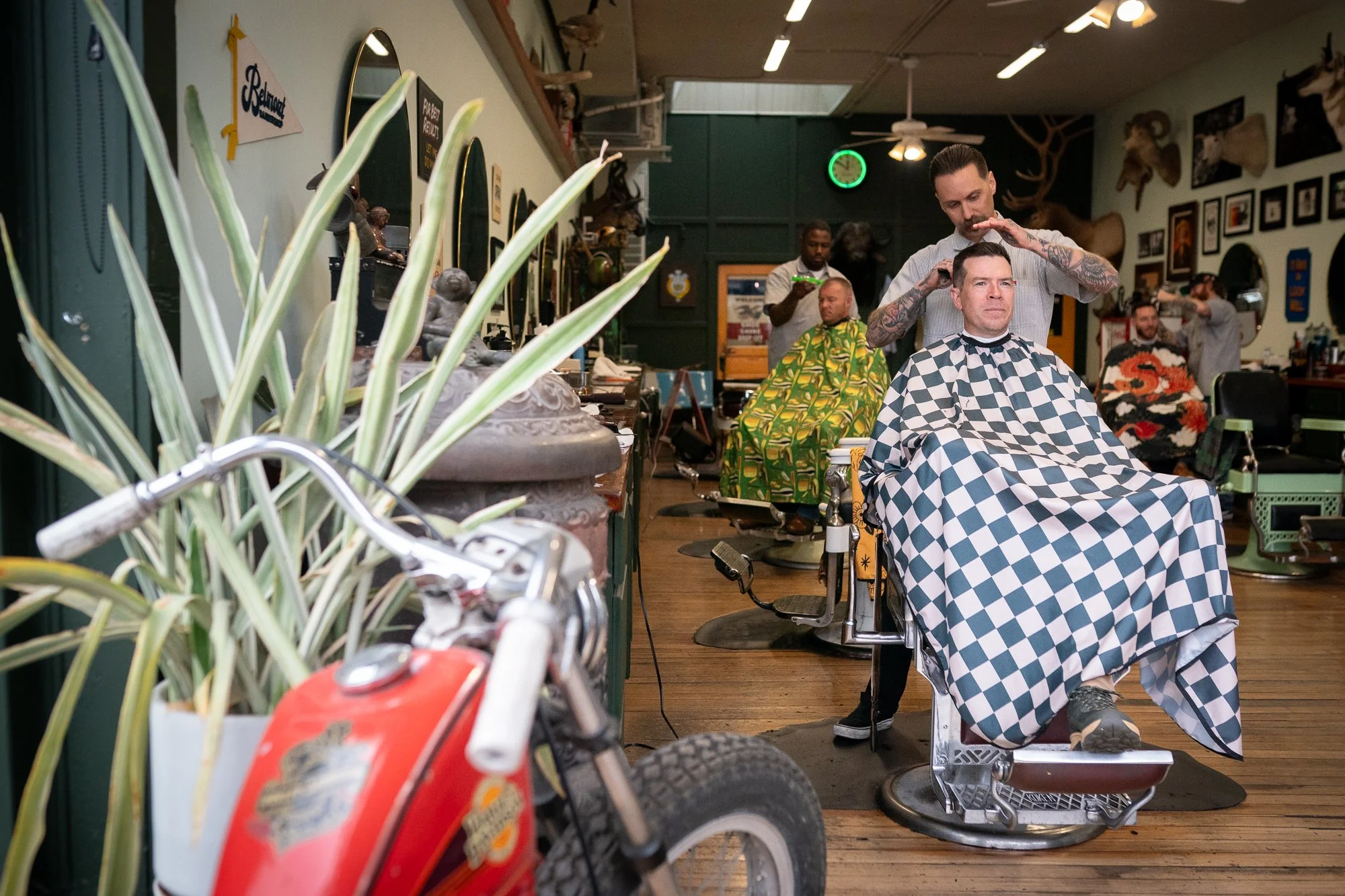 wide interior of Belmont Barbershop in Boise Idaho with barbers working and clients in chairs