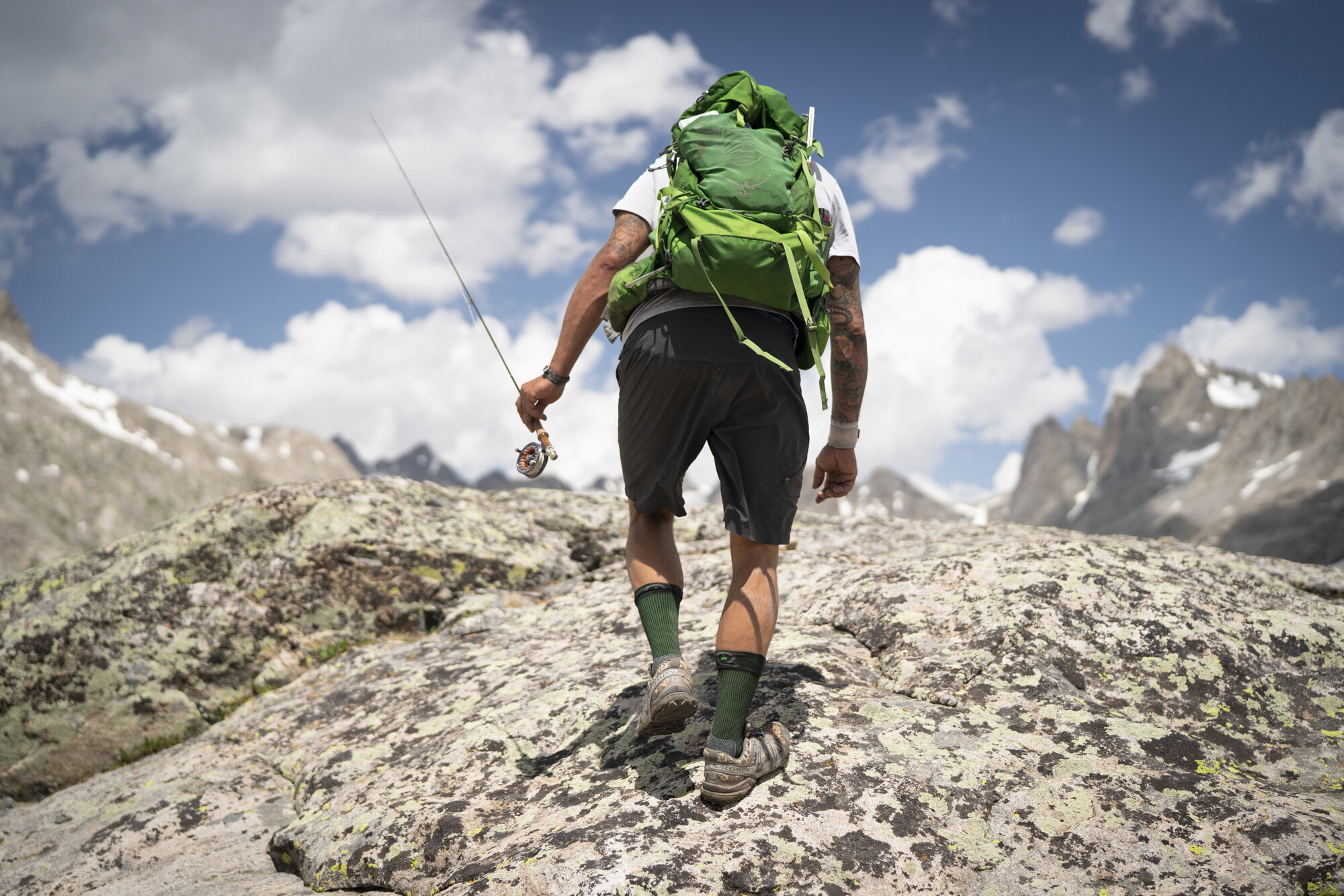  A fly fisherman hikes to a high alpine lake in the Wind River Range - Wyoming.  