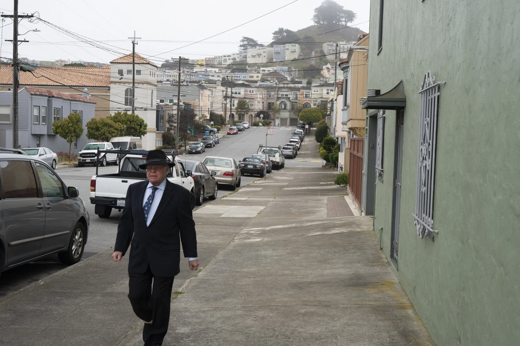  Photograph of a man walking through the Outer Sunset neighborhood of San Francisco, CA 