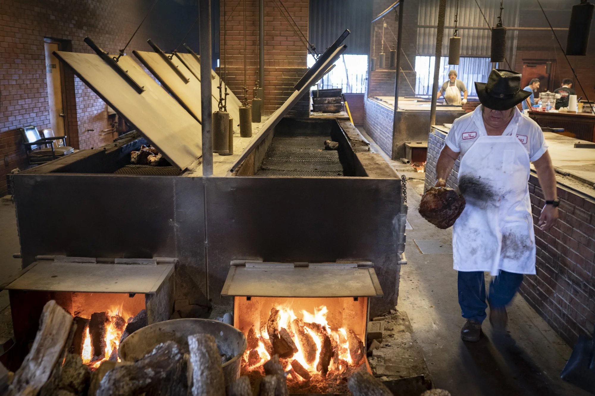 Pitmaster Roy Perez working the pits at Kreuz Market in Lockhart, Texas