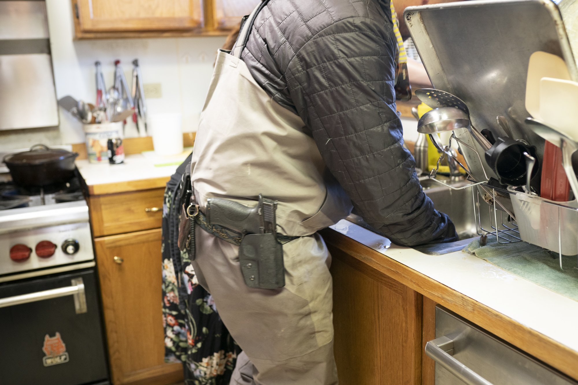  Photograph of a fly fisherman in Alaska with a gun on his belt  