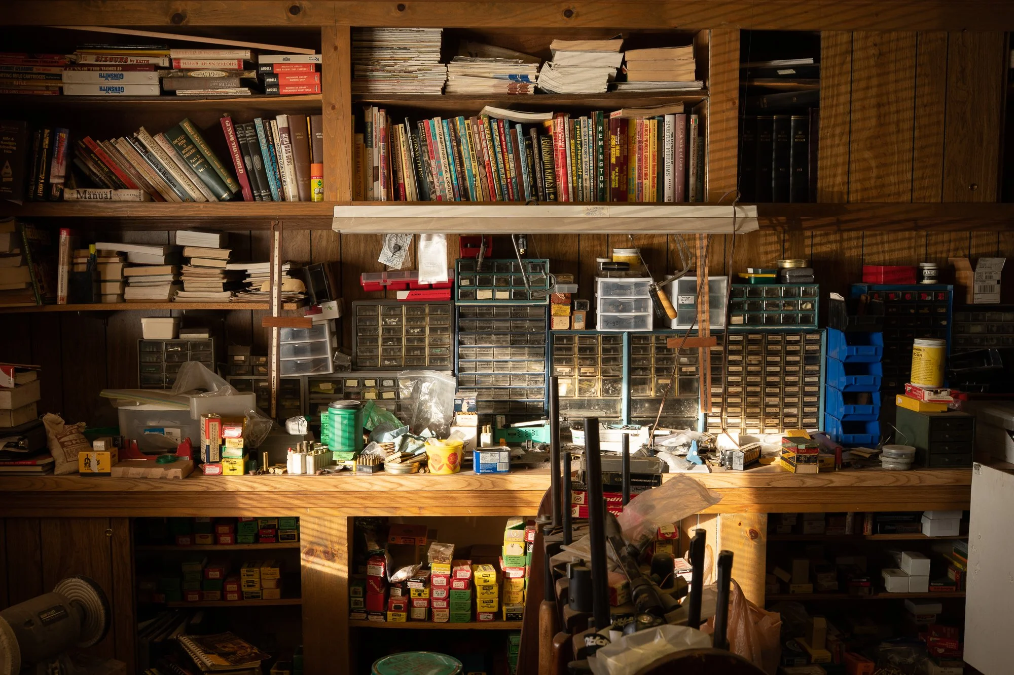 Books tools and supplies on shelves inside a Wyoming ranch workshop