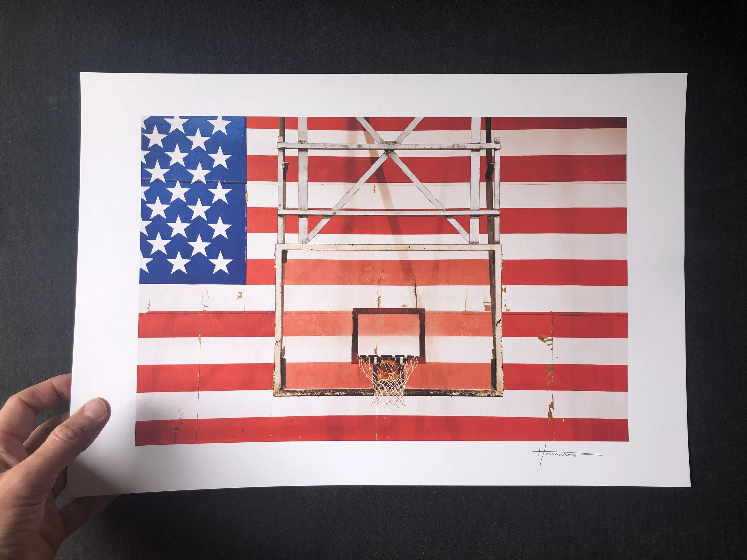 Photography print of a basketball hoop in front of an American Flag