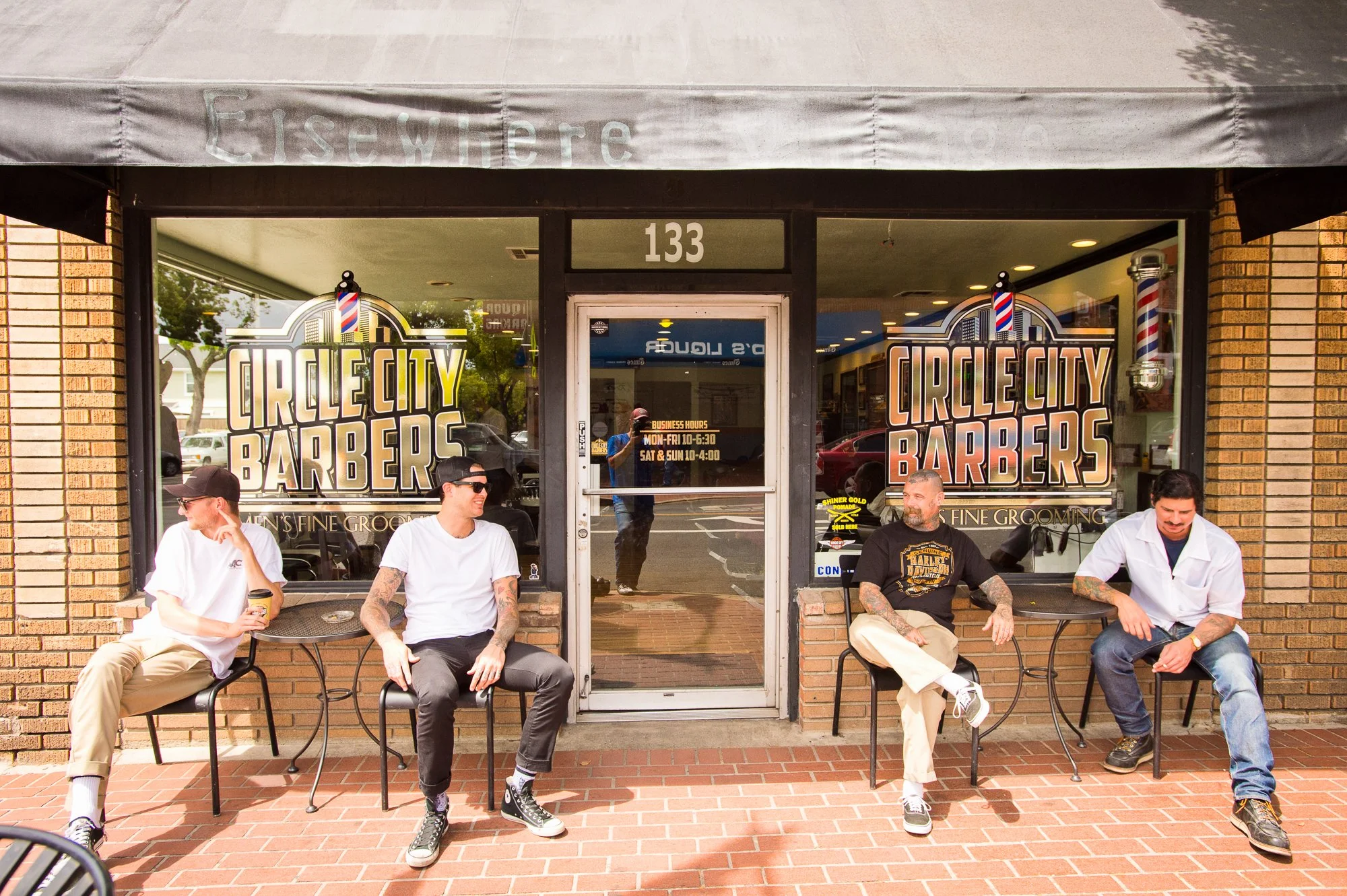  Photograph of people sitting out front of Circle City Barbershop in Orange, California  