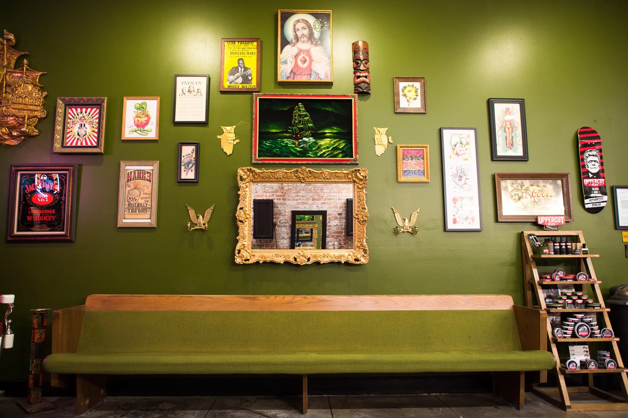  Photograph of pictures and art on the wall at Electric Barbershop in Riverside, California  