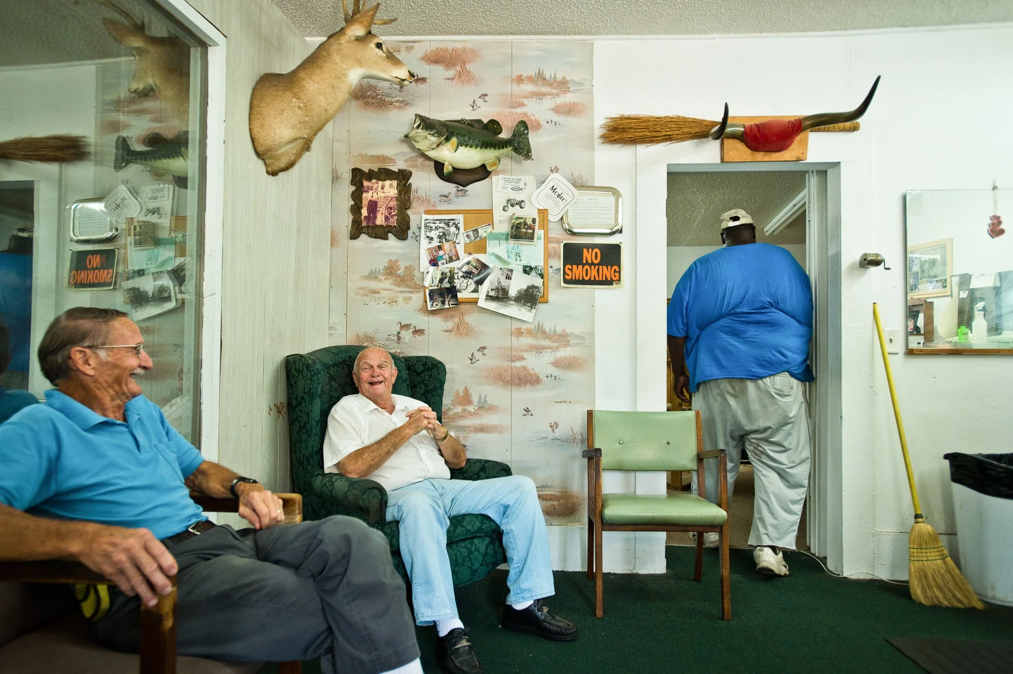  Photograph of friends laughing at an old barbershop in a small Georgia town 