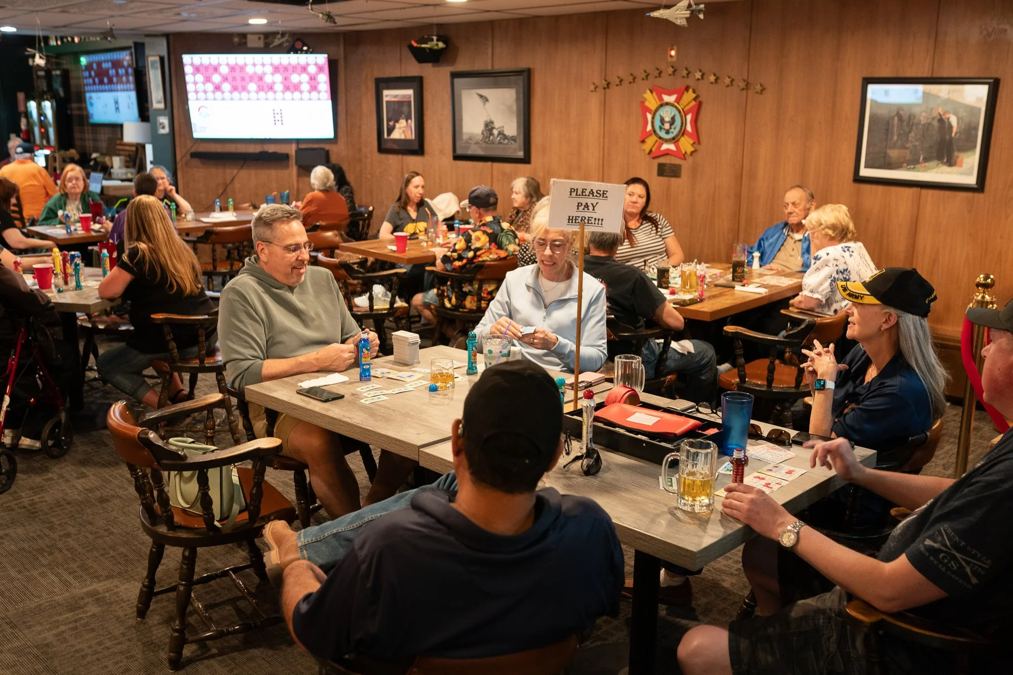 People seated around tables playing bingo inside a VFW hall during a veterans brand campaign