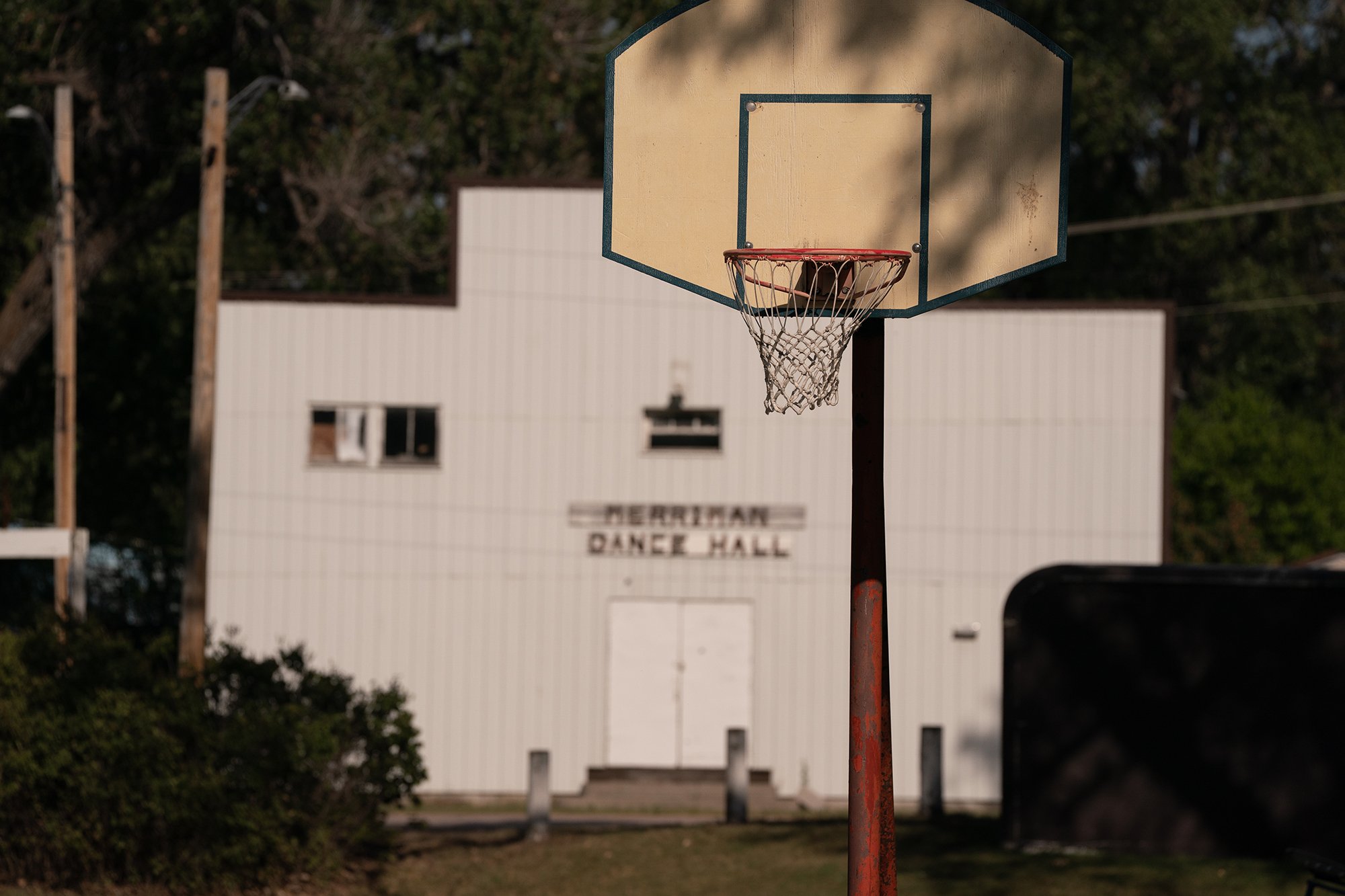  Fine art photograph of a basketball hoop in front of an old dance hall in a small Nebraska town.  