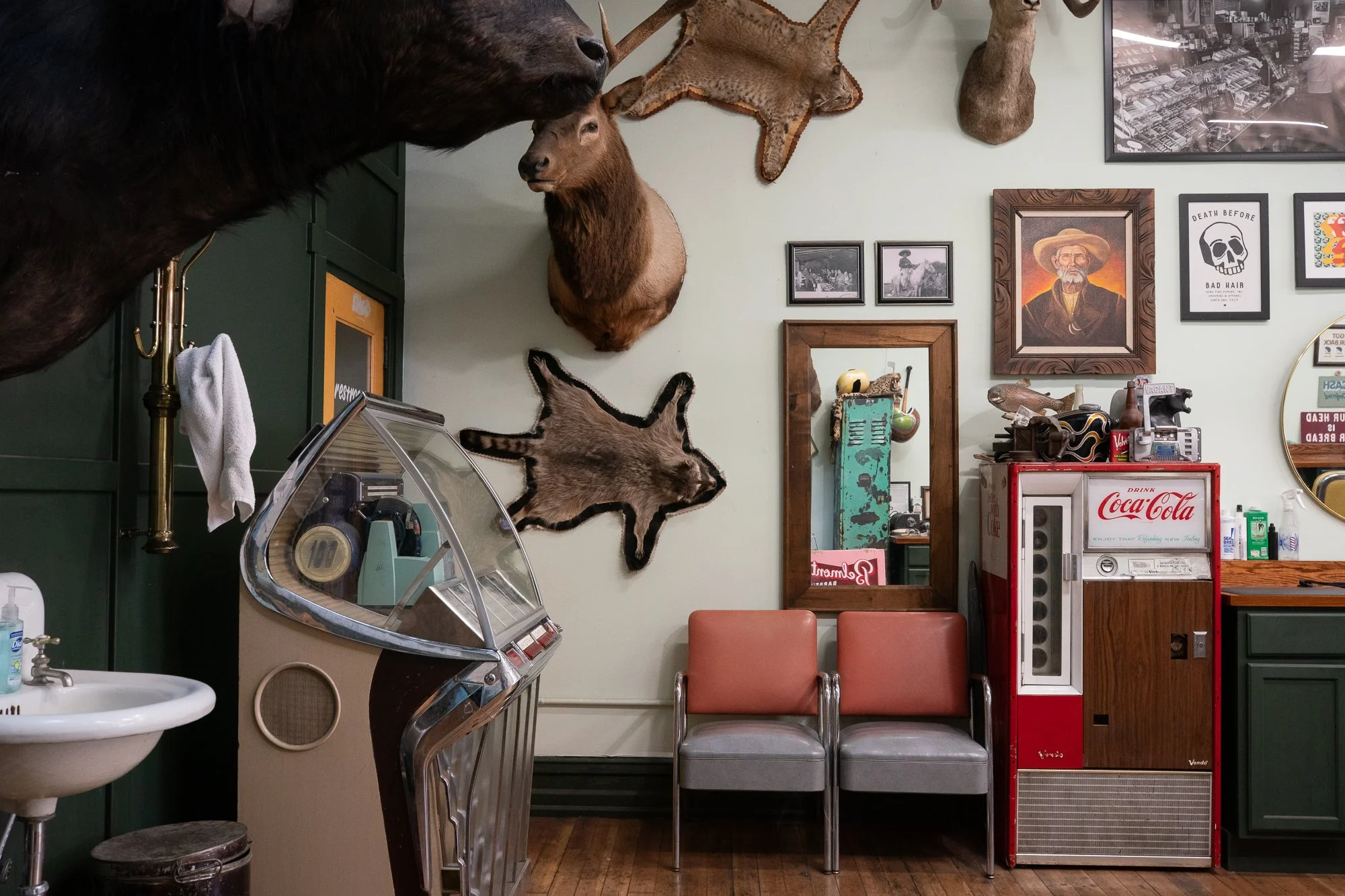 vintage interior of Belmont Barbershop in Boise Idaho with taxidermy, chairs, mirror, and Coca-Cola machine