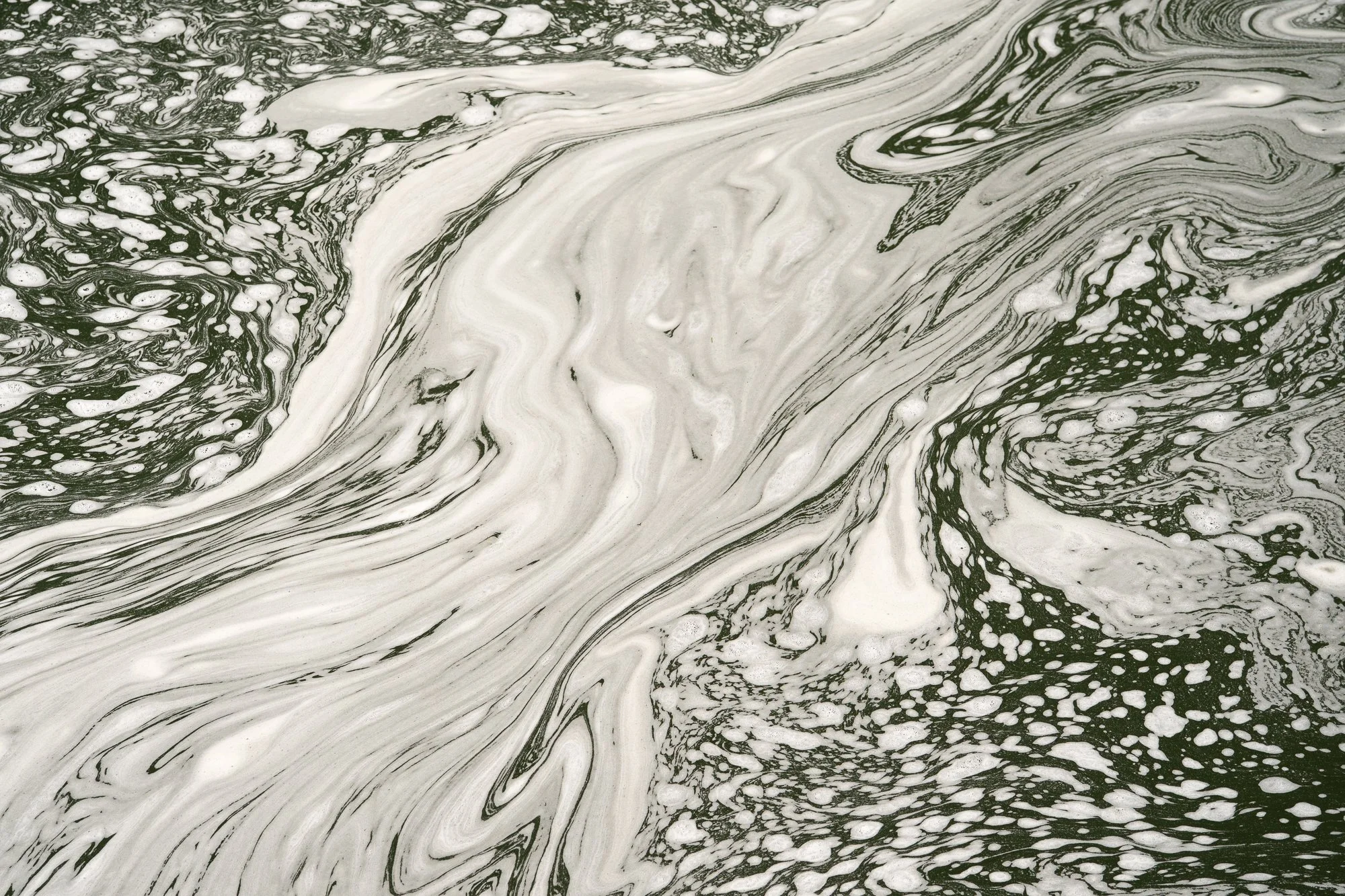 Foam patterns swirl across moving water in the Gunnison River