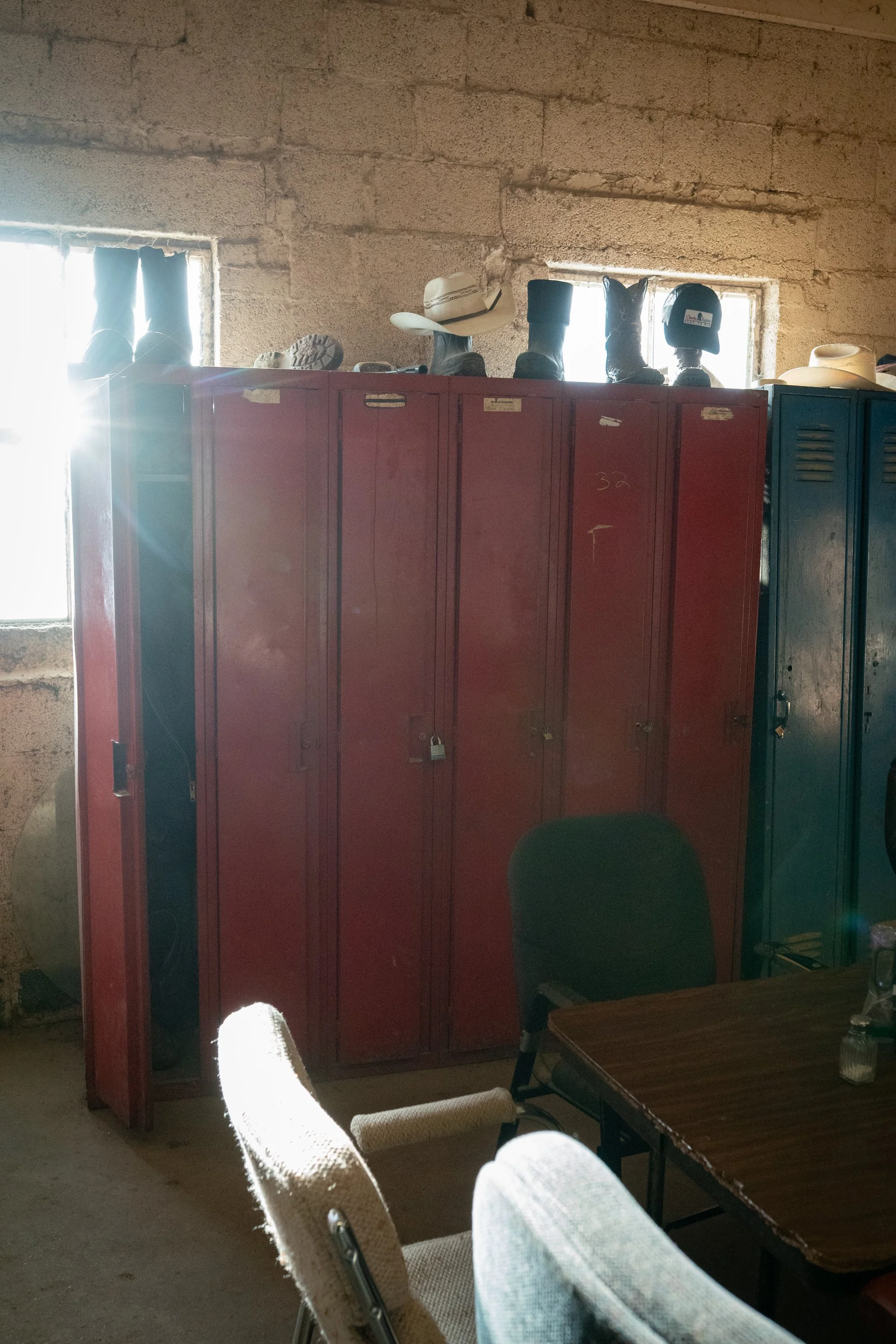 Cowboy boots and hats rest on lockers inside the break room in Colorado