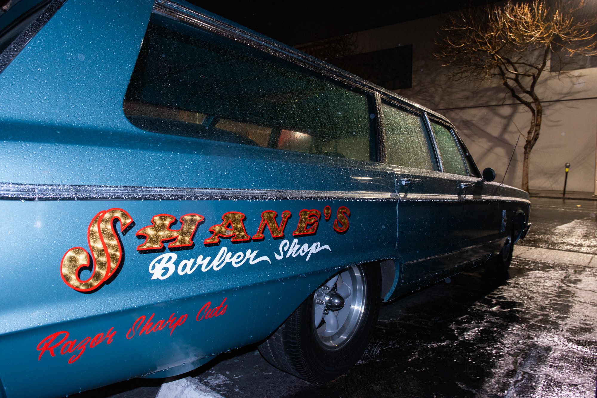 hearse with Shane's Barbershop lettering parked outside at night San Mateo