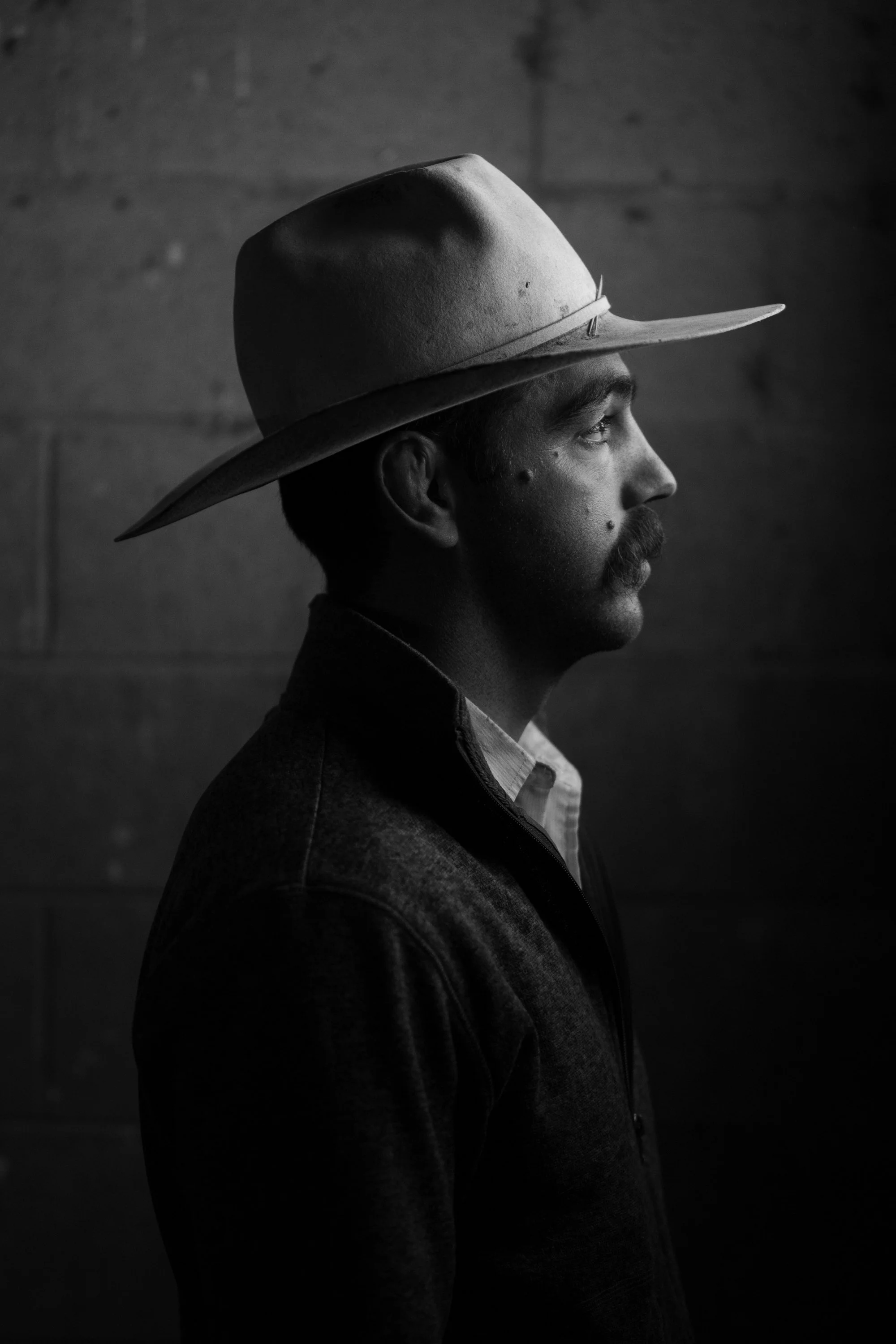 Black-and-white portrait of a pen rider at Magnum Feedyard in Colorado