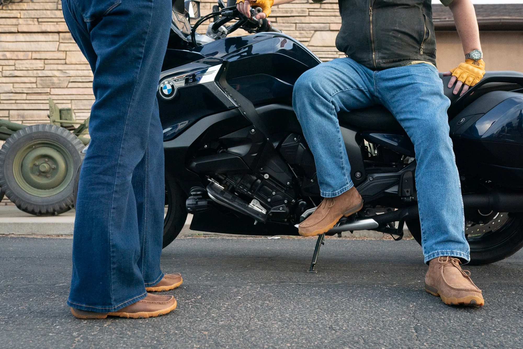 Twisted X boots worn beside a motorcycle outside a VFW hall during a veterans brand campaign