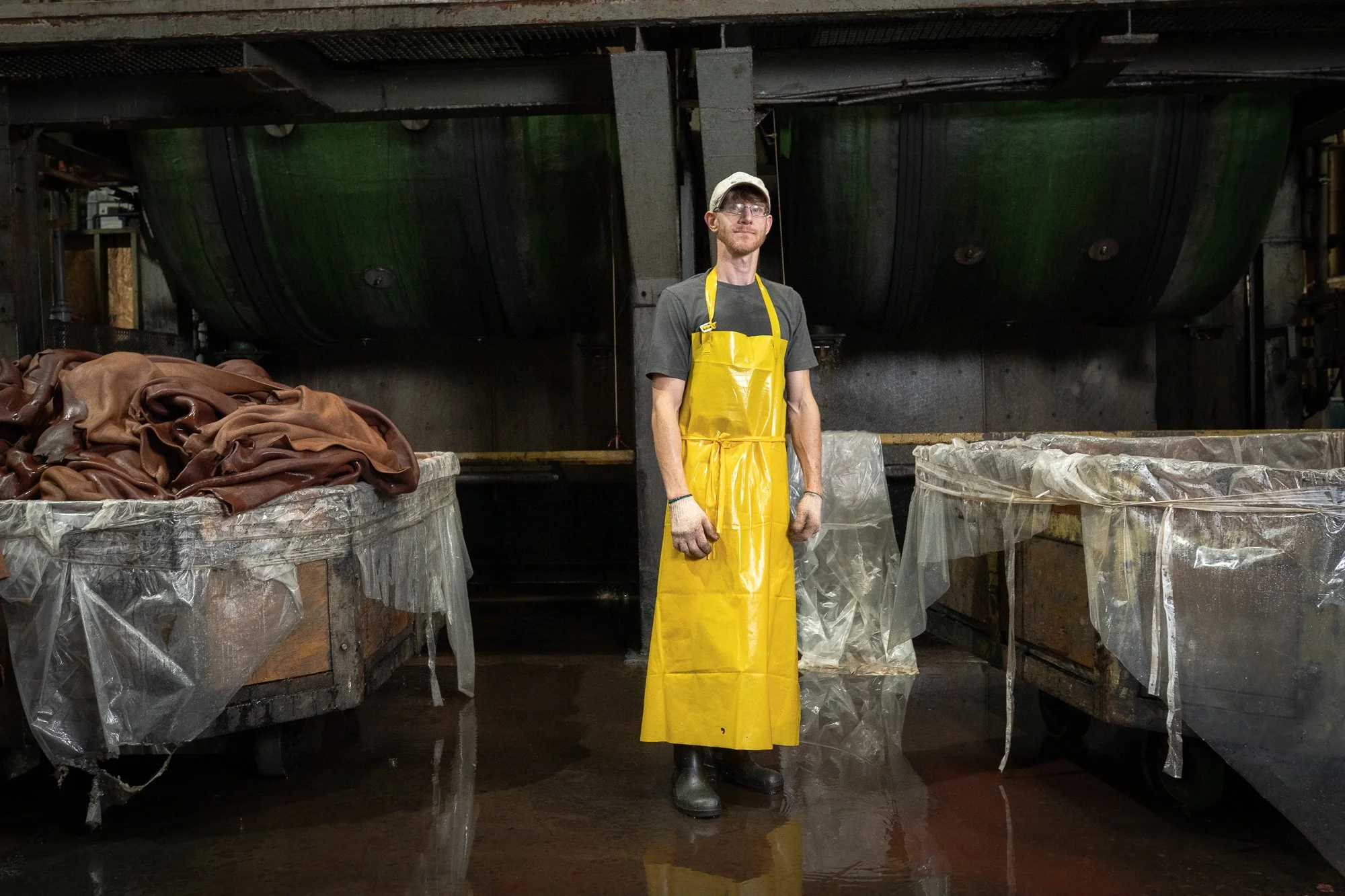 A portrait surrounded by carts loaded with leather on the tannery's production floor
