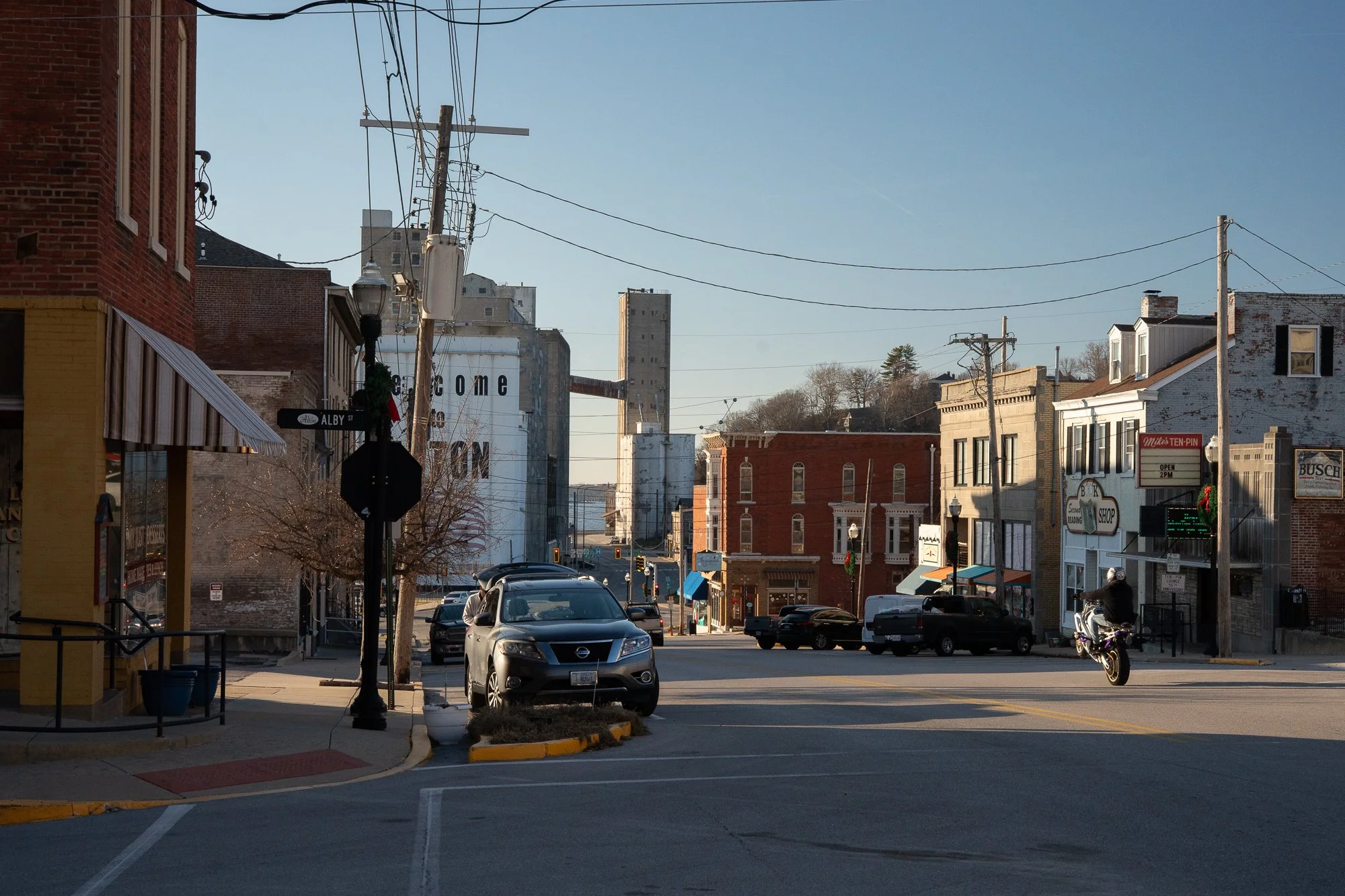 Downtown street with cars leading toward grain elevators in Alton, Illinois