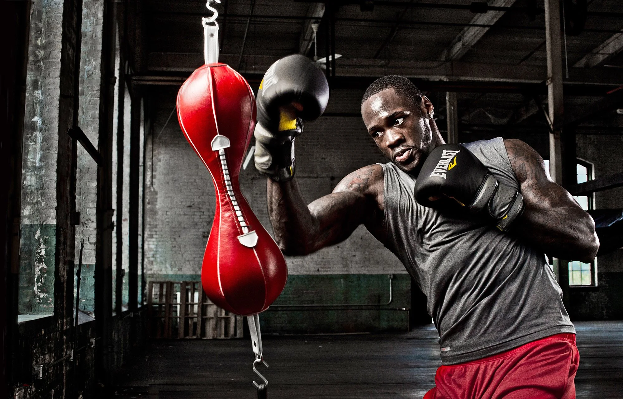 Boxer training with speed bag in gritty gym environment