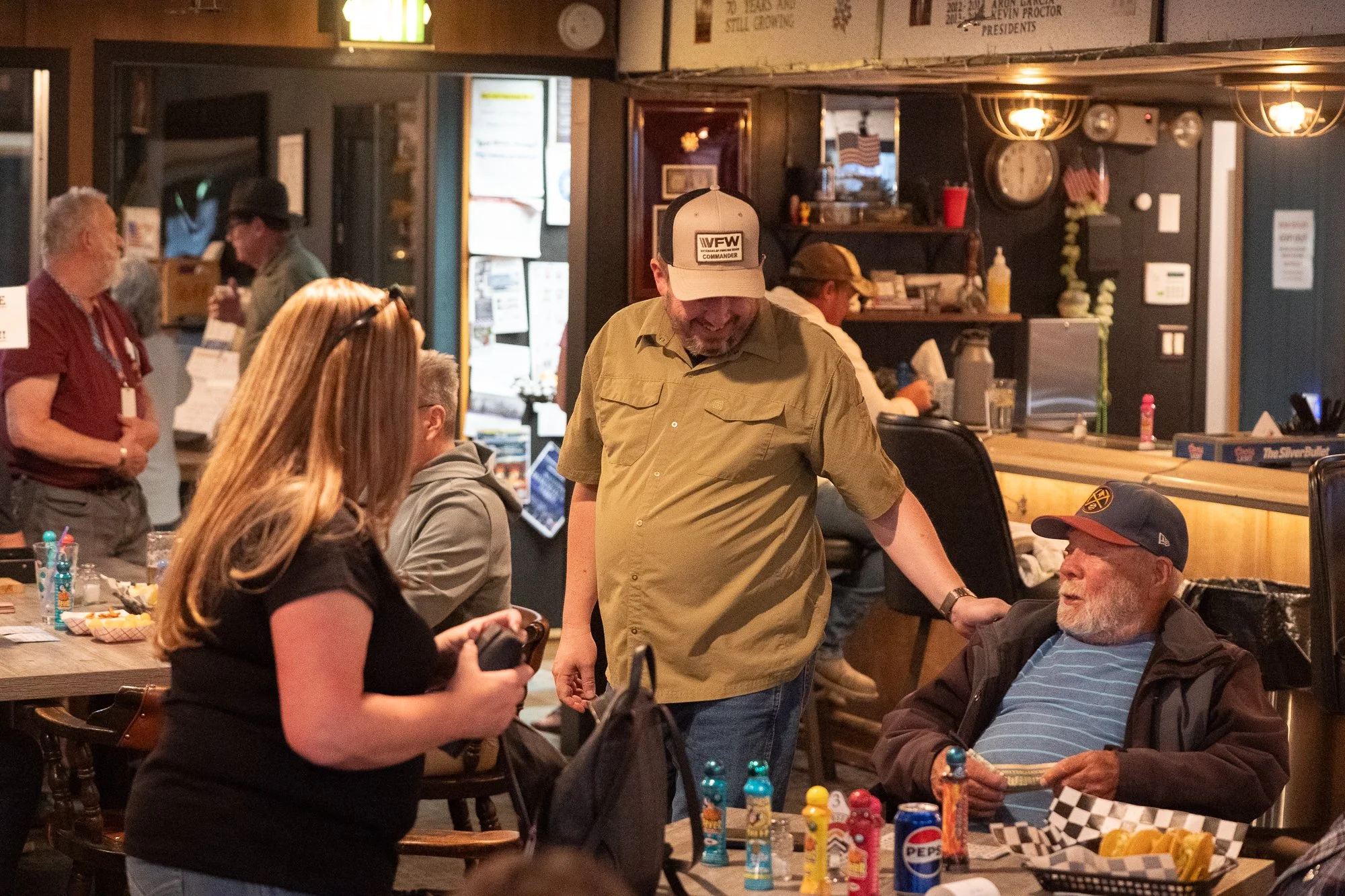 People talking inside a VFW hall during an authentic veterans brand photography campaign
