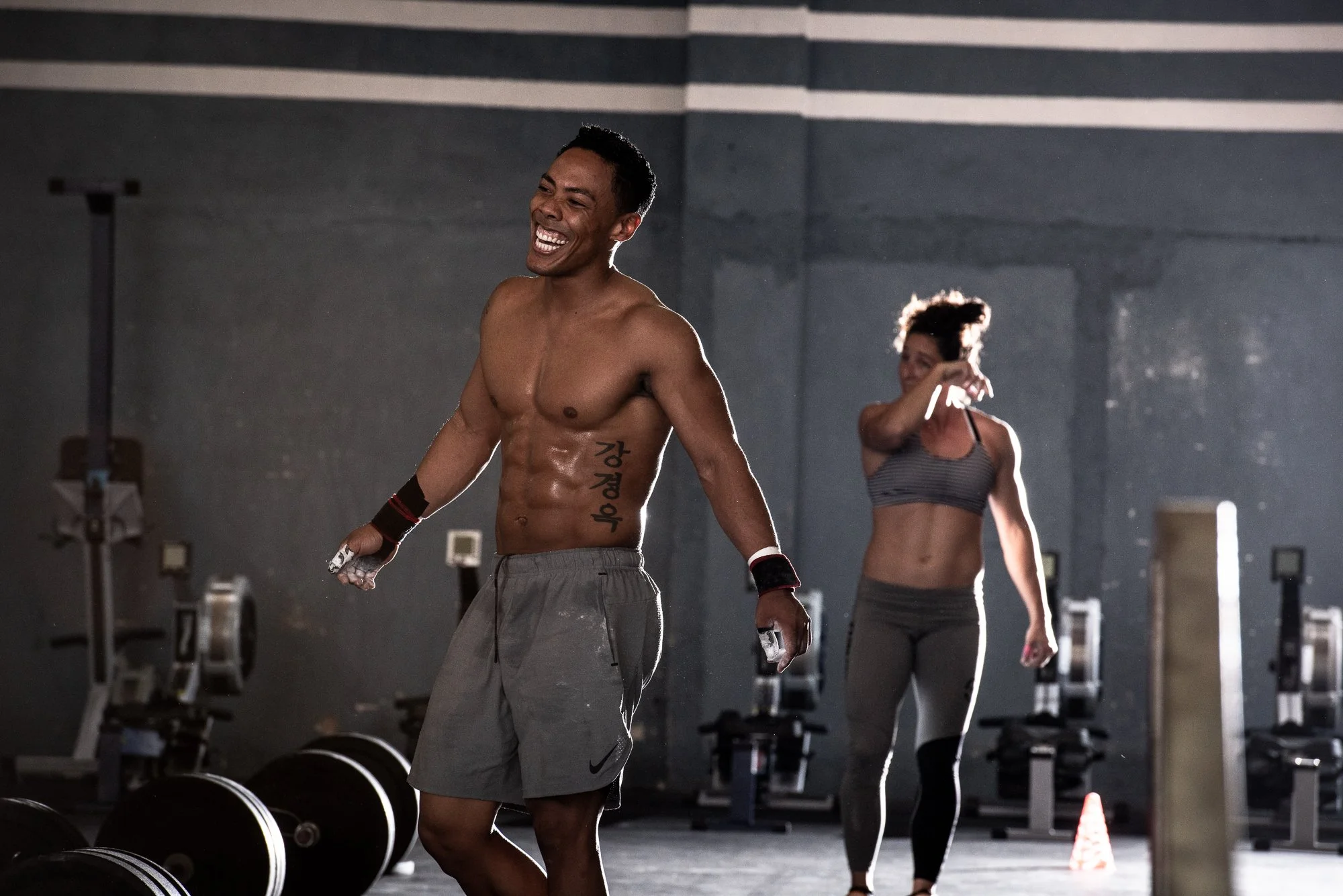 CrossFit athlete walking between barbells during a training session.
