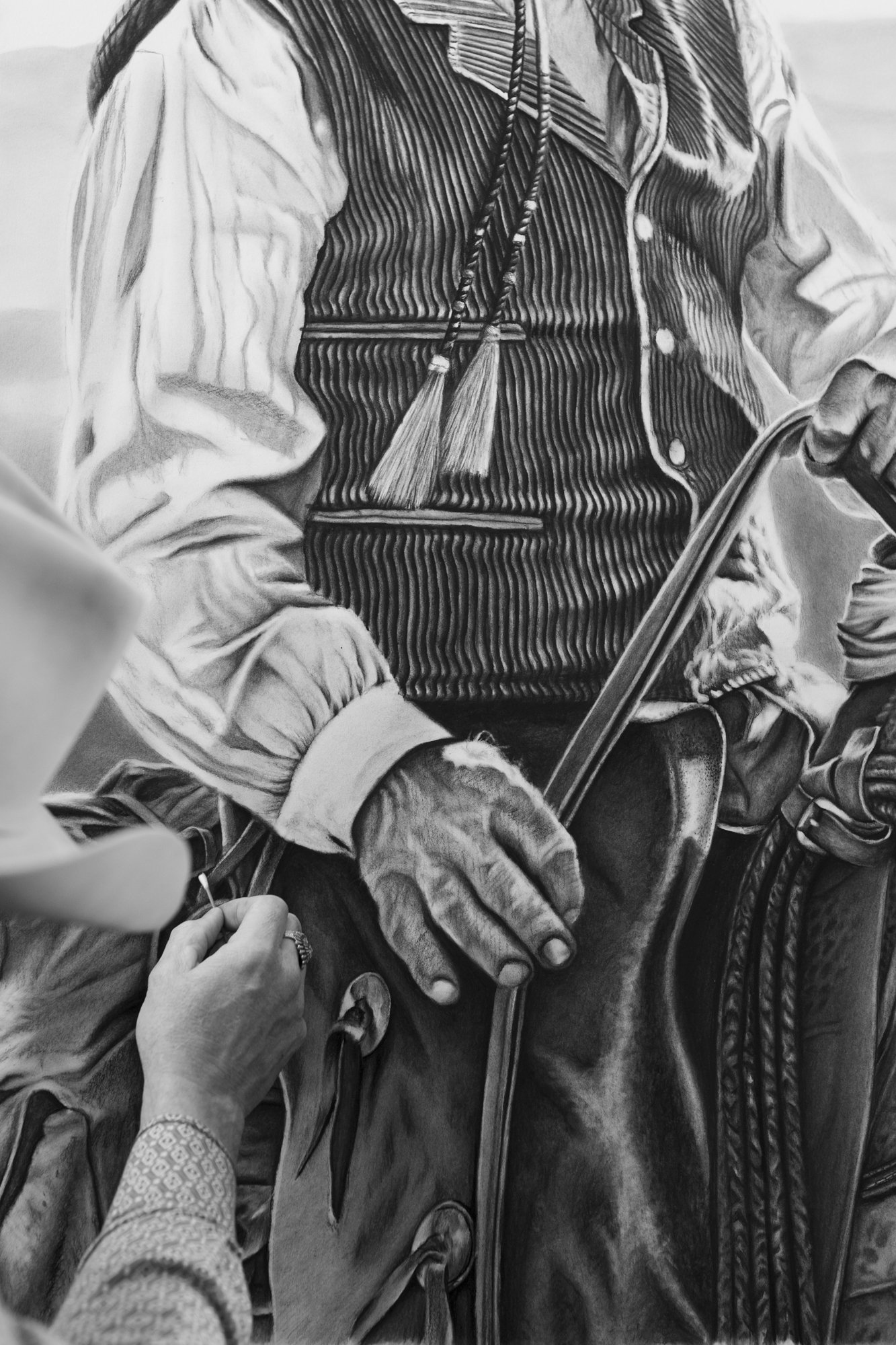 A western charcoal artist drawing a cowboy