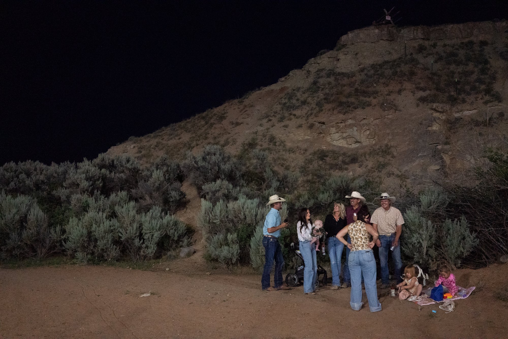 Families gather and visit together after the rodeo beneath the hills outside Dubois Wyoming