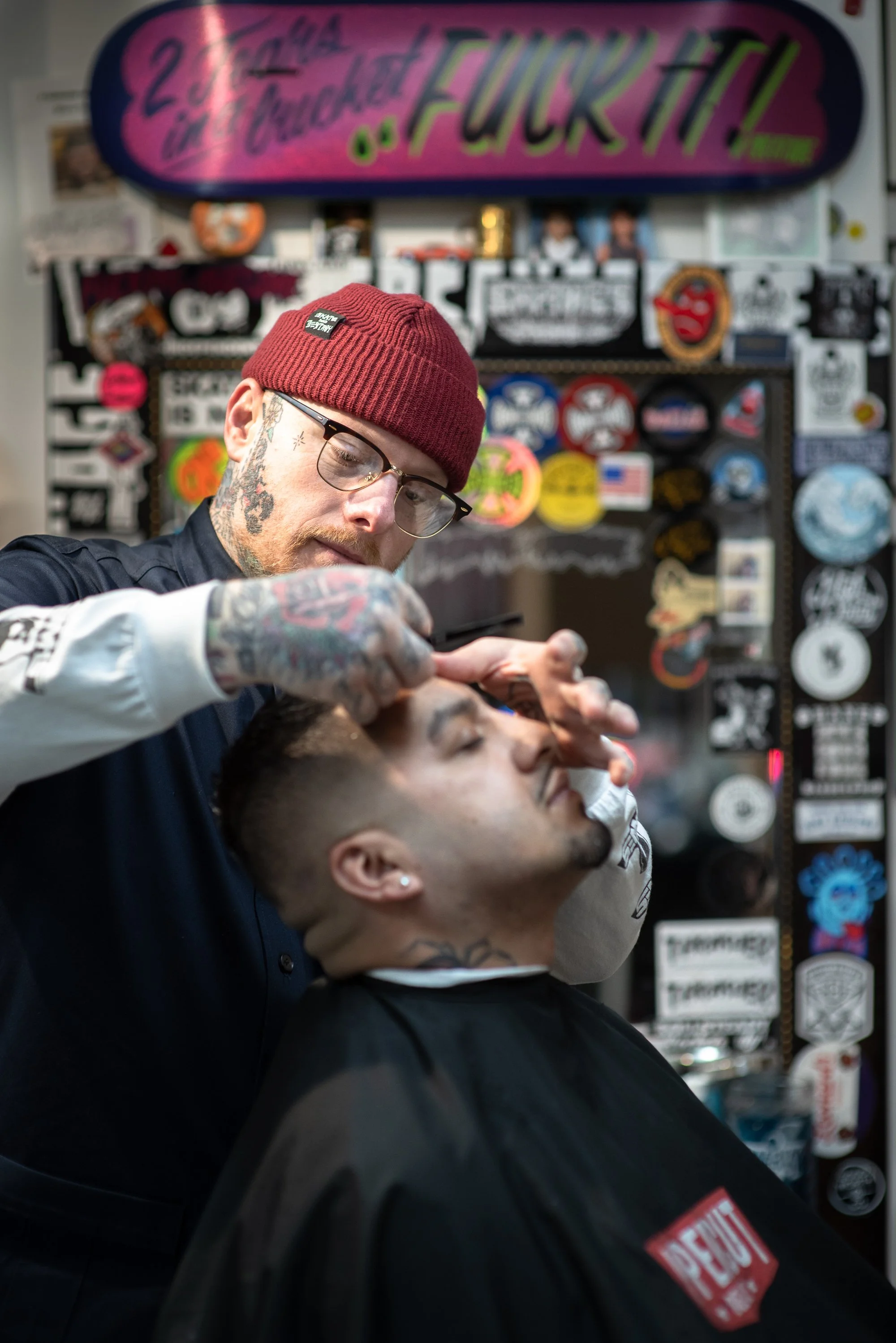 barber Shane Nesbitt giving detailed haircut to client inside Shane's Barbershop San Mateo