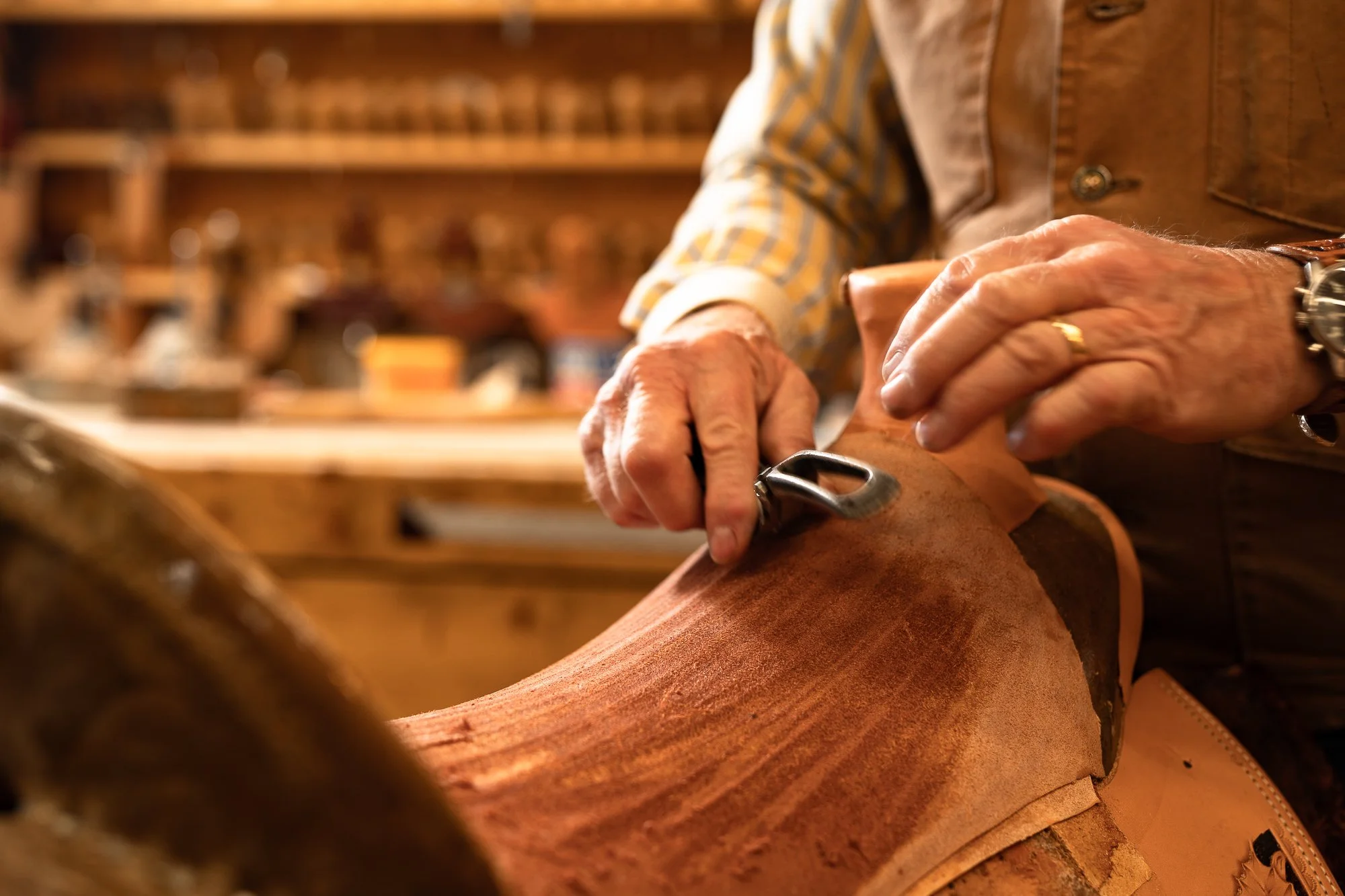 Detail of hand-shaped leather on a Western saddle in a saddle shop