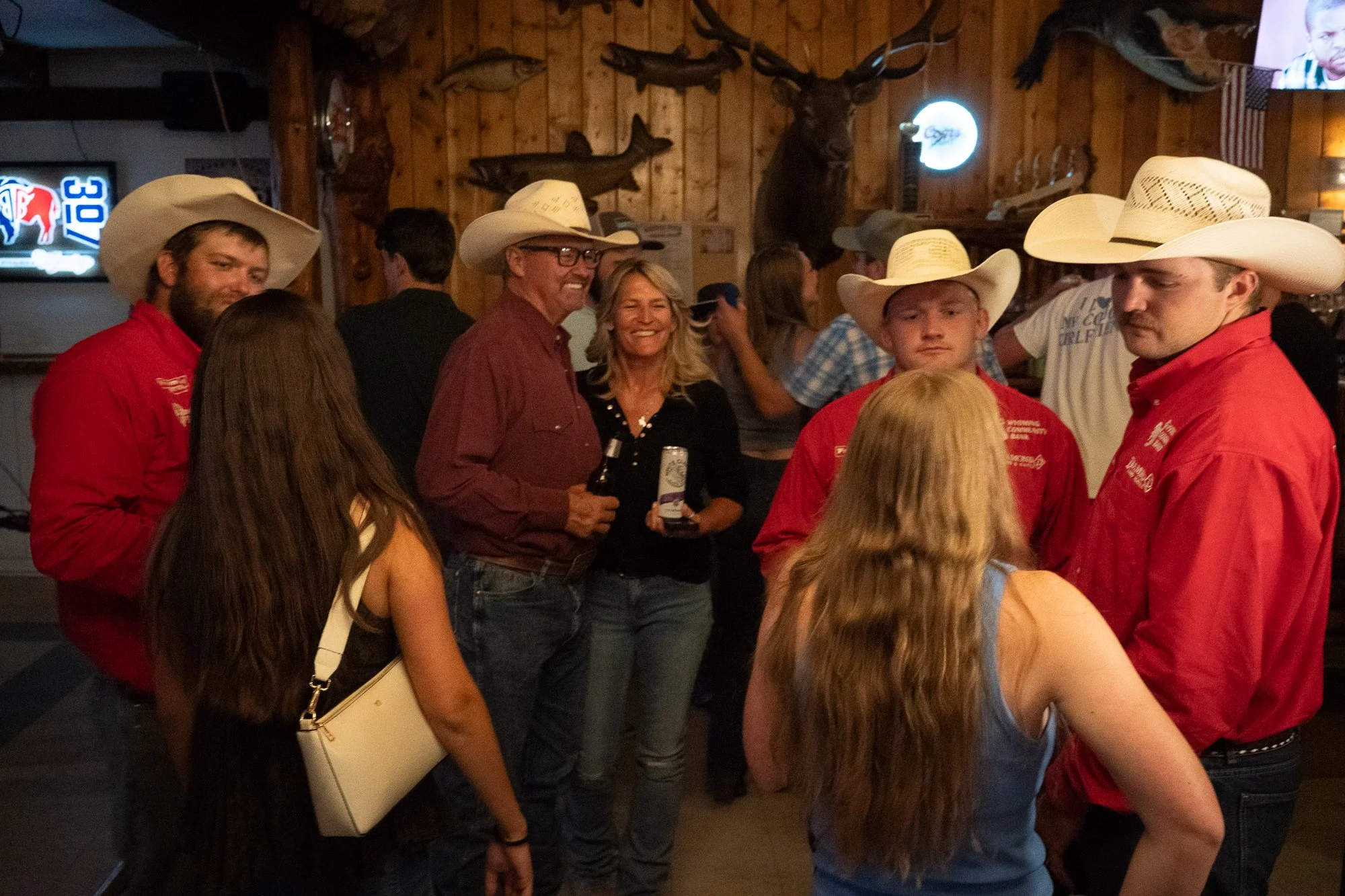 Cowboys and community members visit together inside the Rustic Pine Tavern in Dubois Wyoming