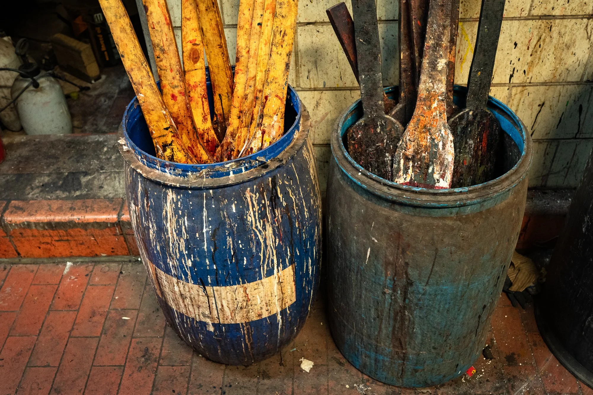 Worn tools stand in two barrels inside the Wickett & Craig tannery