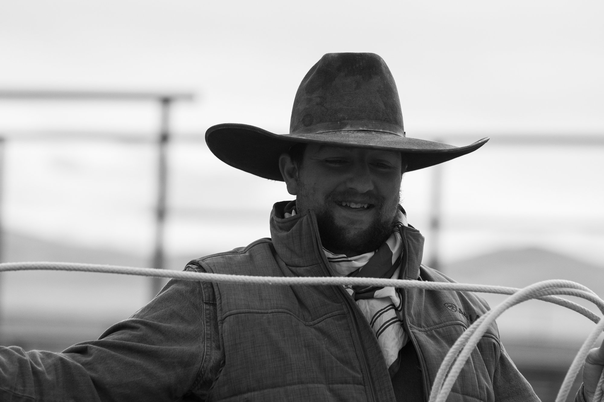 Black and white portrait of smiling cowboy at TS Ranch