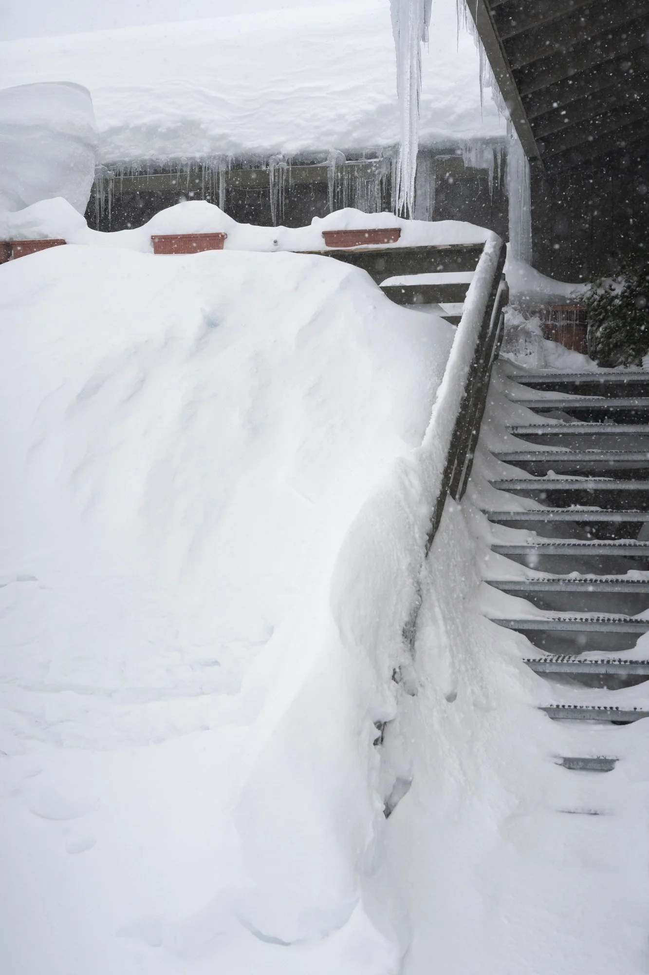 Photograph of a house covered in deep snow after a storm in Mammoth, CA