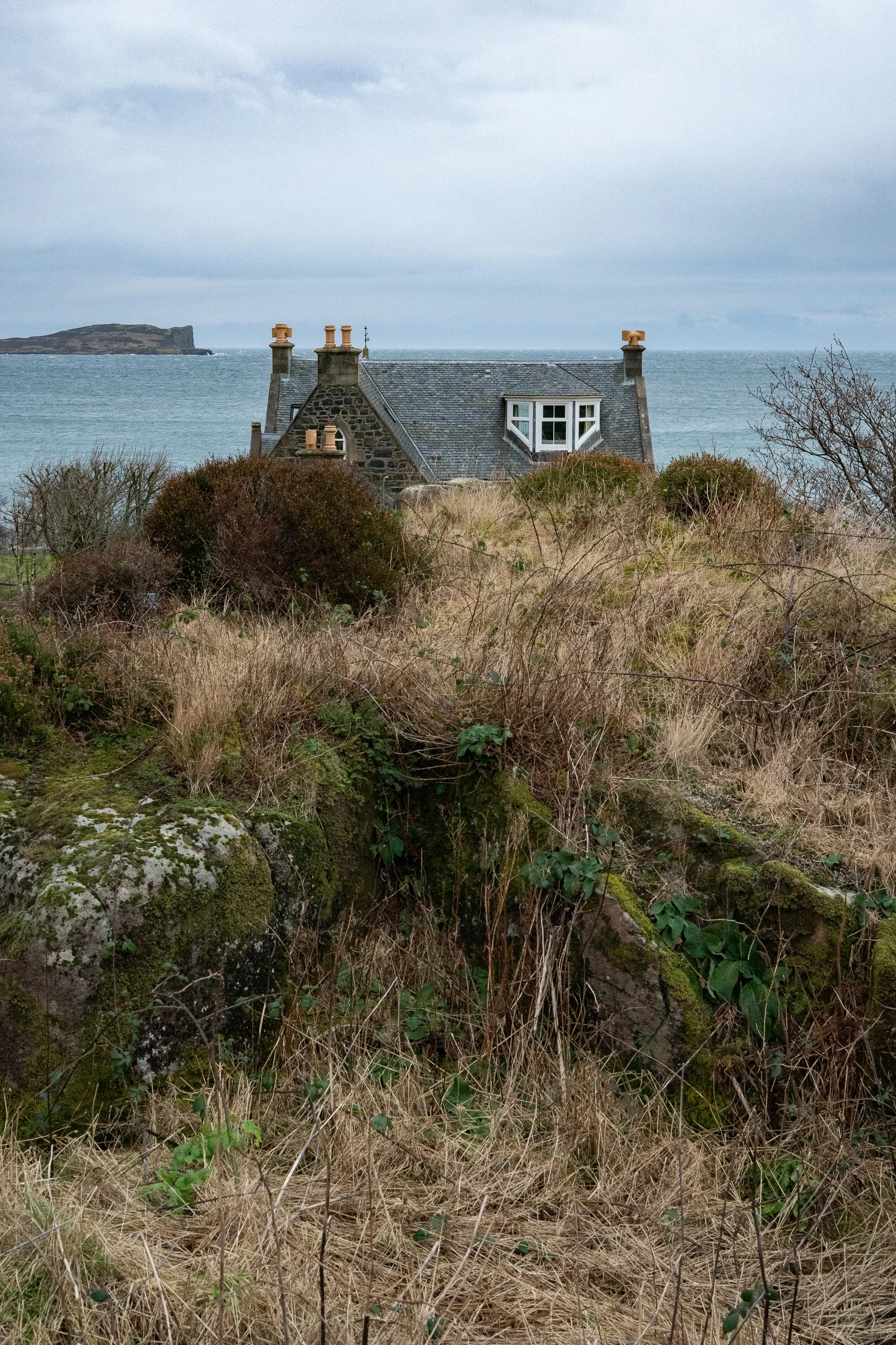 Stone cottage overlooking the sea in the Scottish Highlands, fine art coastal landscape photography print.